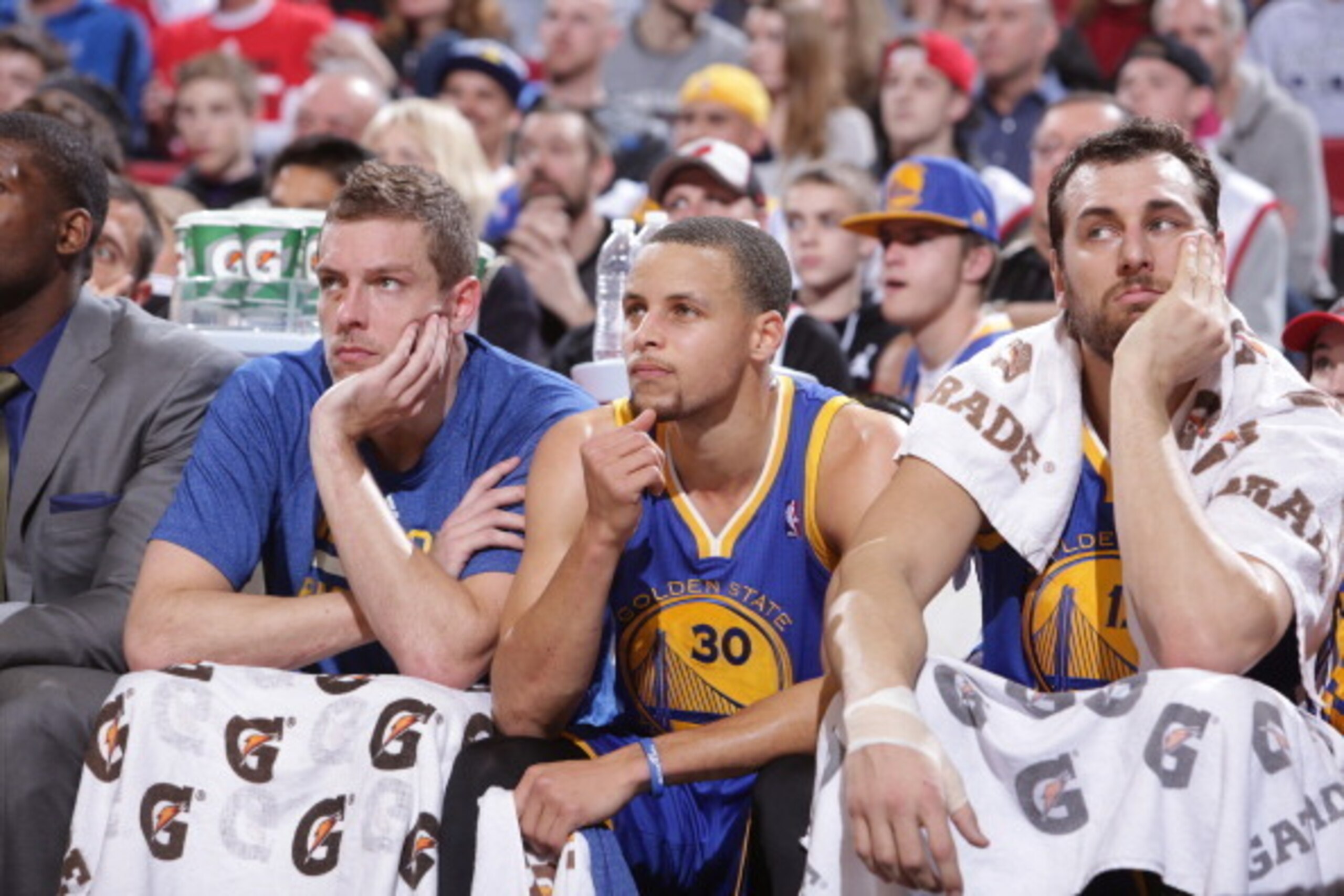 PORTLAND, OR - MARCH 16: David Lee #10, Stephen Curry #30 and Andrew Bogut #12 of the Golden State Warriors on the bench during the game against the Portland Trail Blazers on March 16, 2014 at the Moda Center Arena in Portland, Oregon. NOTE TO USER: User 