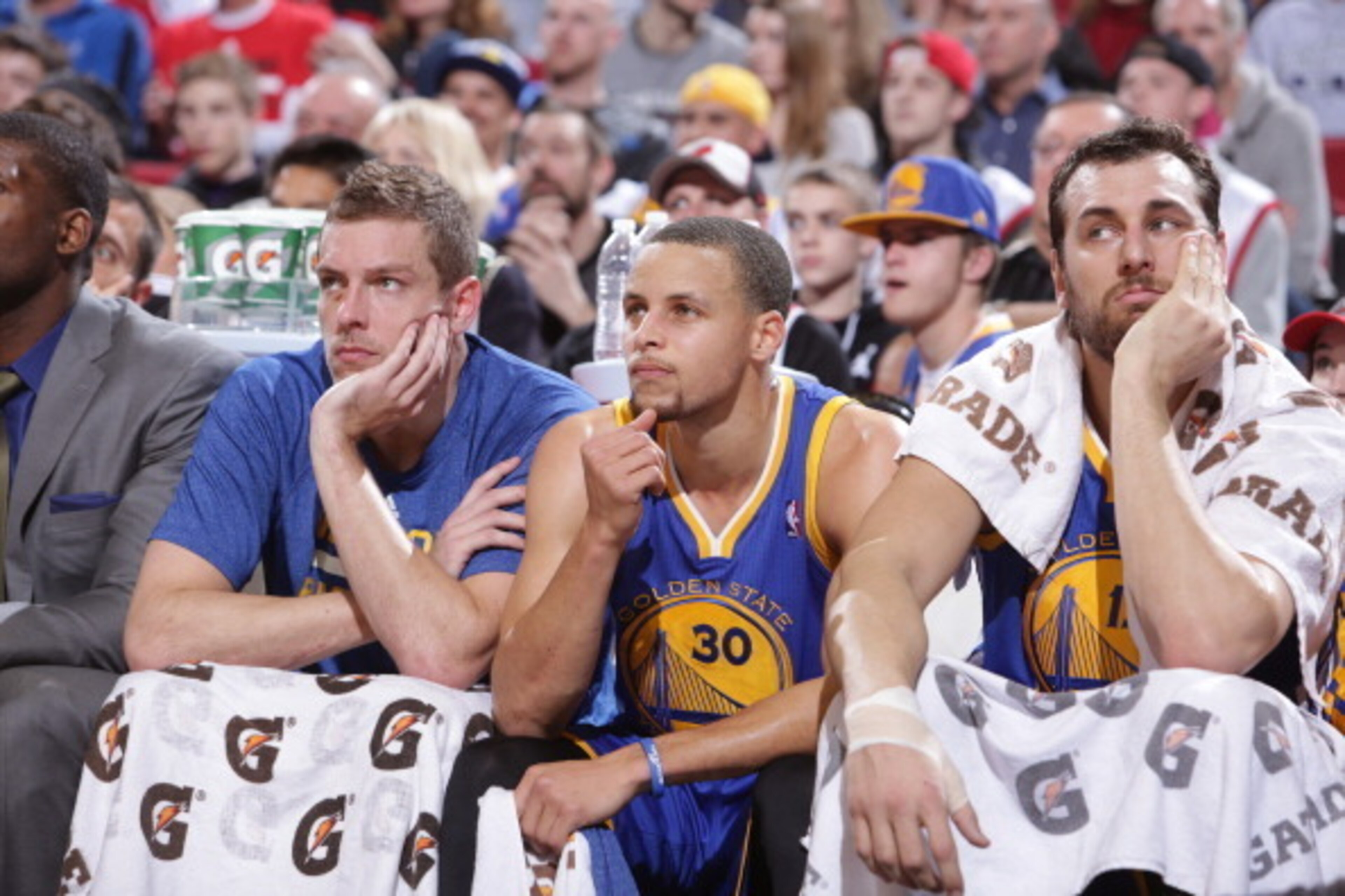PORTLAND, OR - MARCH 16: David Lee #10, Stephen Curry #30 and Andrew Bogut #12 of the Golden State Warriors on the bench during the game against the Portland Trail Blazers on March 16, 2014 at the Moda Center Arena in Portland, Oregon. NOTE TO USER: User 