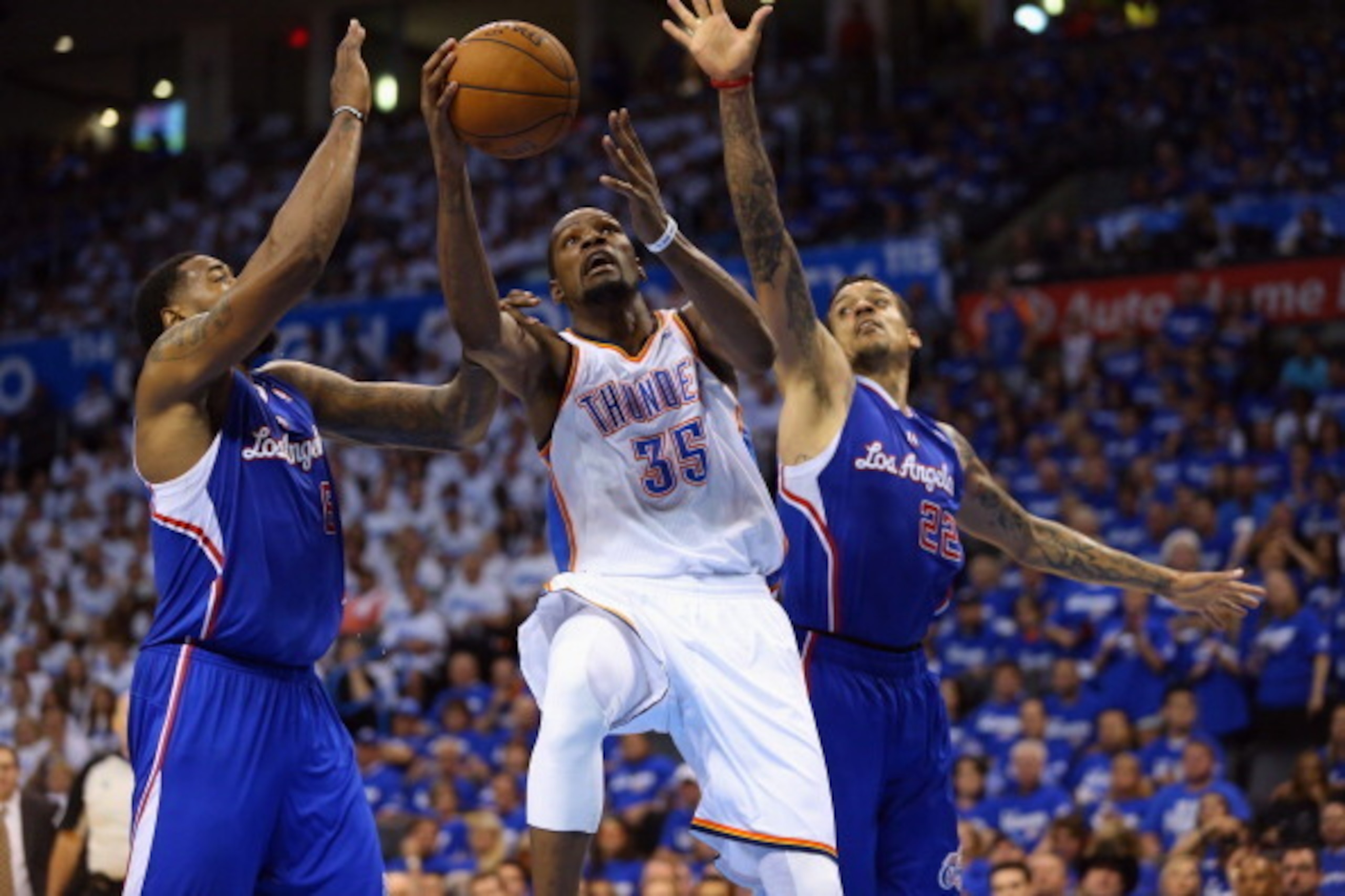 OKLAHOMA CITY, OK - MAY 07:  Kevin Durant #35 of the Oklahoma City Thunder takes a shot against DeAndre Jordan #6 and Matt Barnes #22 of the Los Angeles Clippers in Game Two of the Western Conference Semifinals during the 2014 NBA Playoffs at Chesapeake E