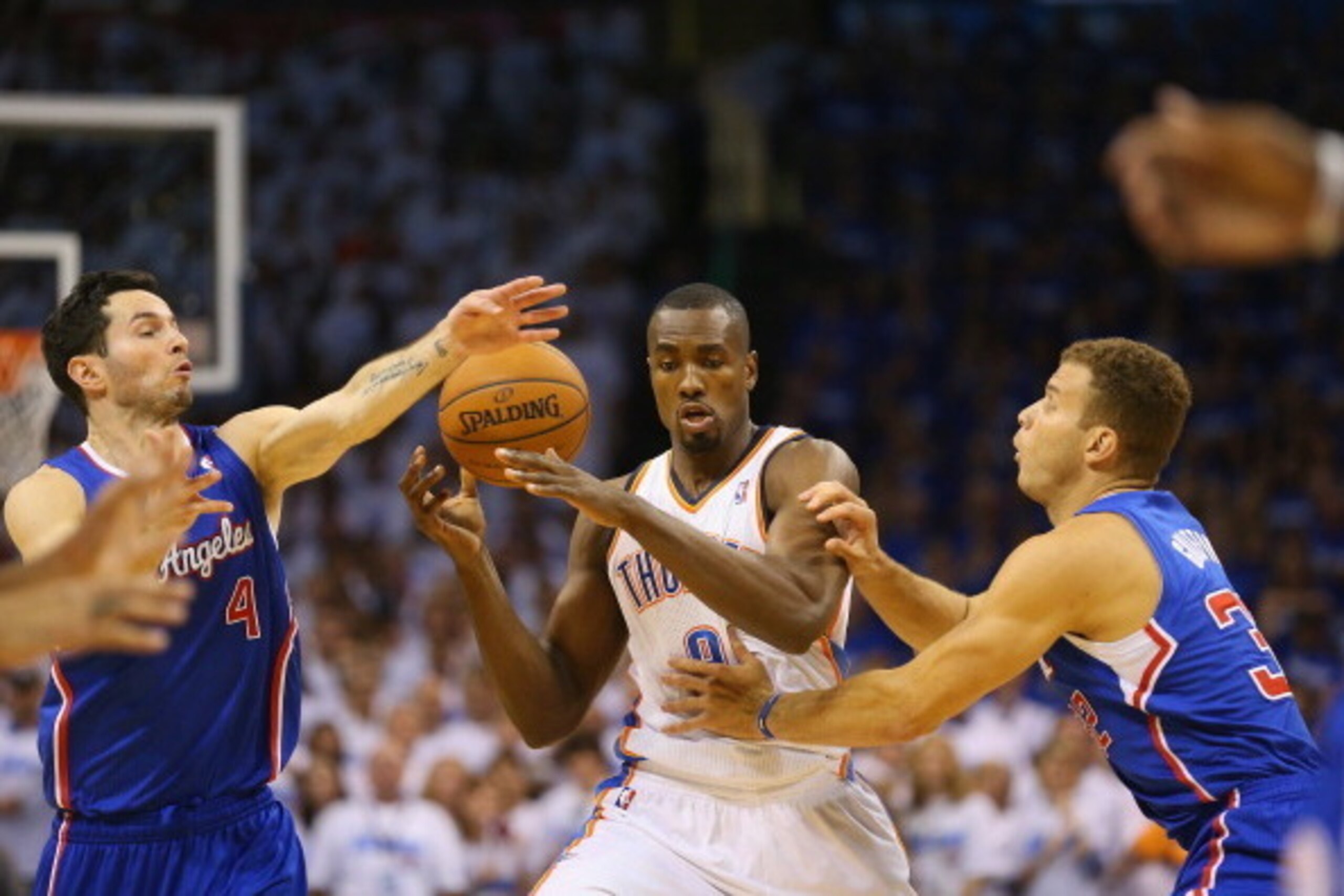 OKLAHOMA CITY, OK - MAY 07:  Serge Ibaka #9 of the Oklahoma City Thunder dribbles the ball against J.J. Redick #4 and Blake Griffin #32 of the Los Angeles Clippers in Game Two of the Western Conference Semifinals during the 2014 NBA Playoffs at Chesapeake
