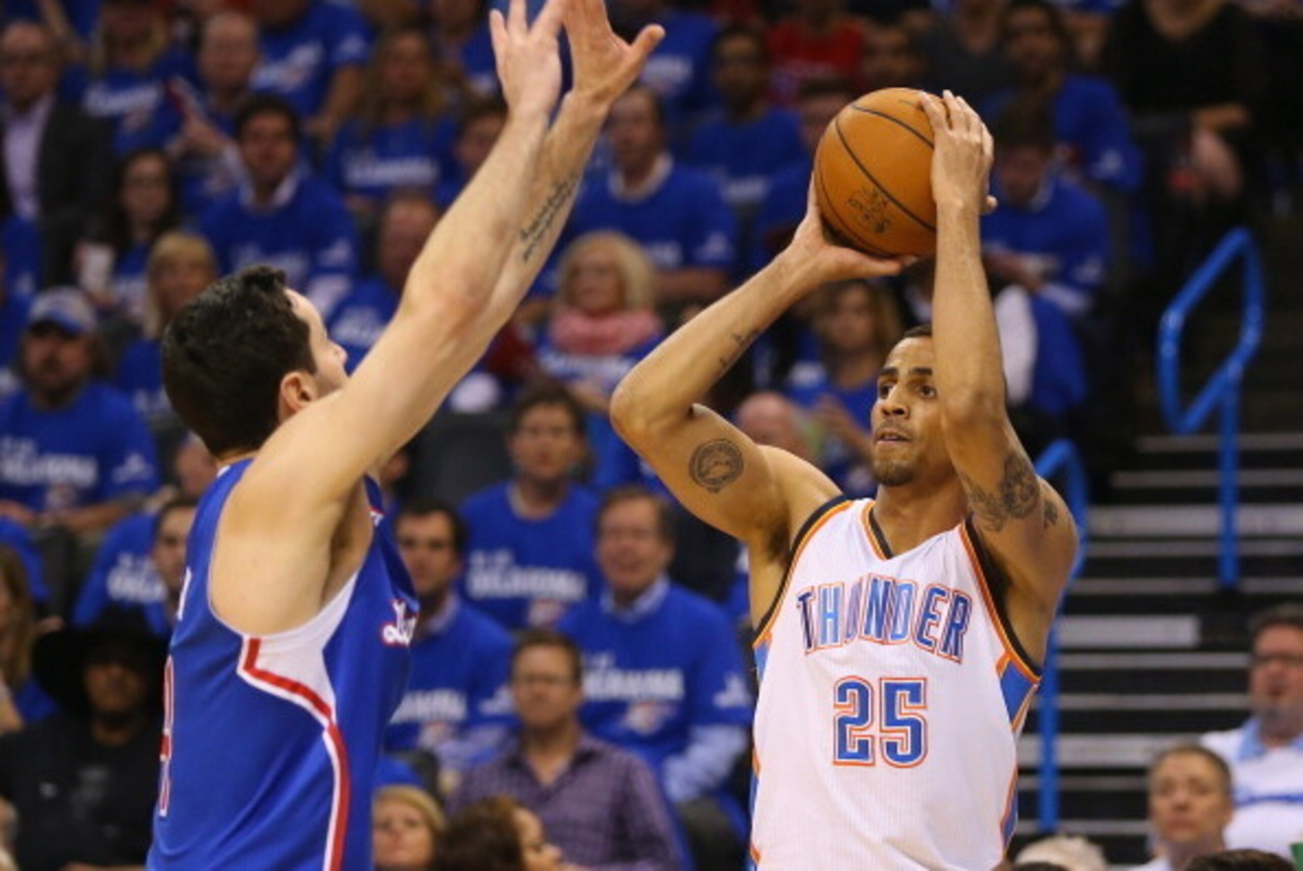 OKLAHOMA CITY, OK - MAY 07:  Thabo Sefolosha #25 of the Oklahoma City Thunder takes a shot against J.J. Redick #4 of the Los Angeles Clippers in Game Two of the Western Conference Semifinals during the 2014 NBA Playoffs at Chesapeake Energy Arena on May 7
