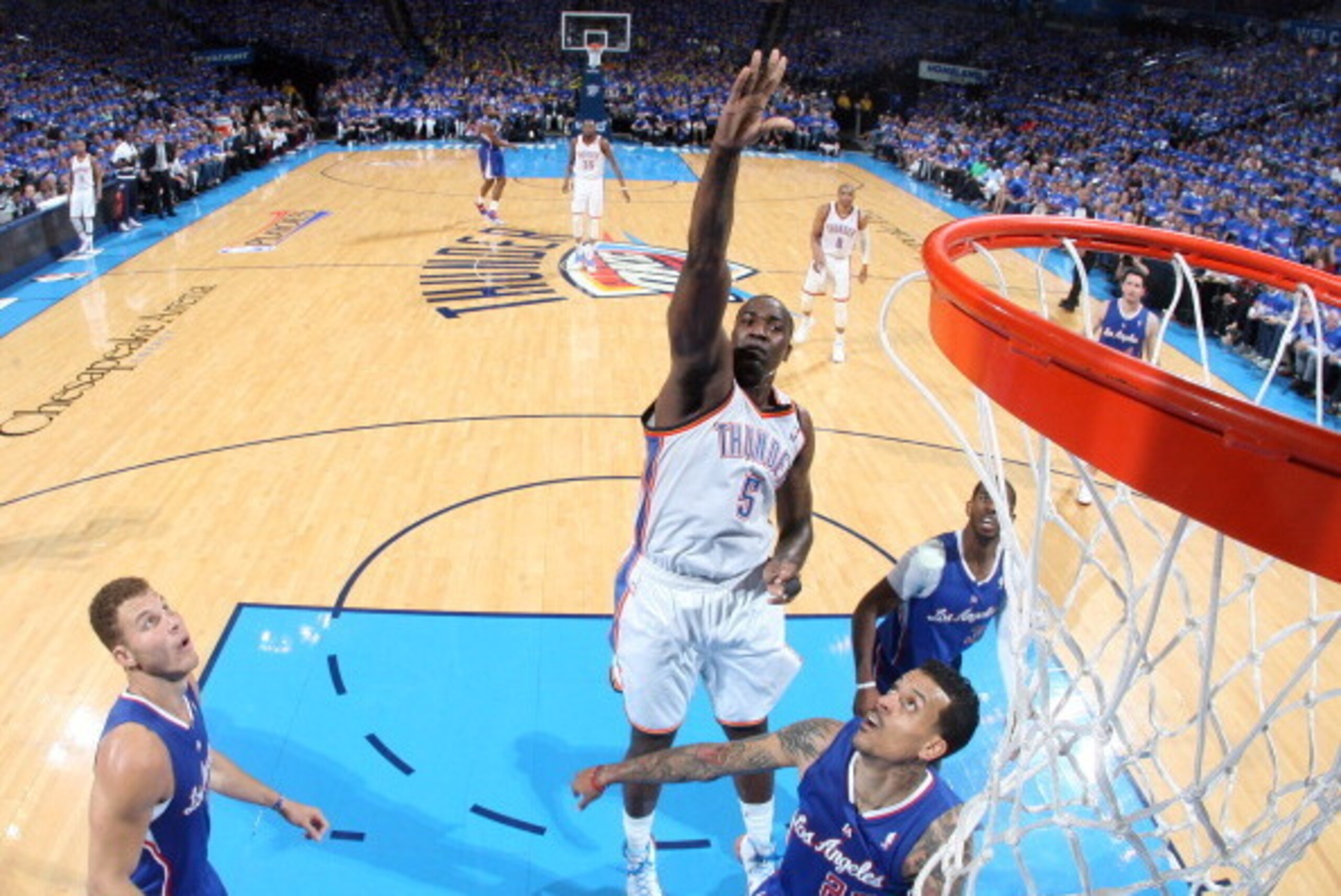 OKLAHOMA CITY, OK - May 5, 2014: Kendrick Perkins #5 of the Oklahoma City Thunder goes up for the layup against the Los Angeles Clippers in Game 1 of the Western Conference Semifinals during the 2014 NBA Playoffs at the Chesapeake Arena on May 5, 2014 in 