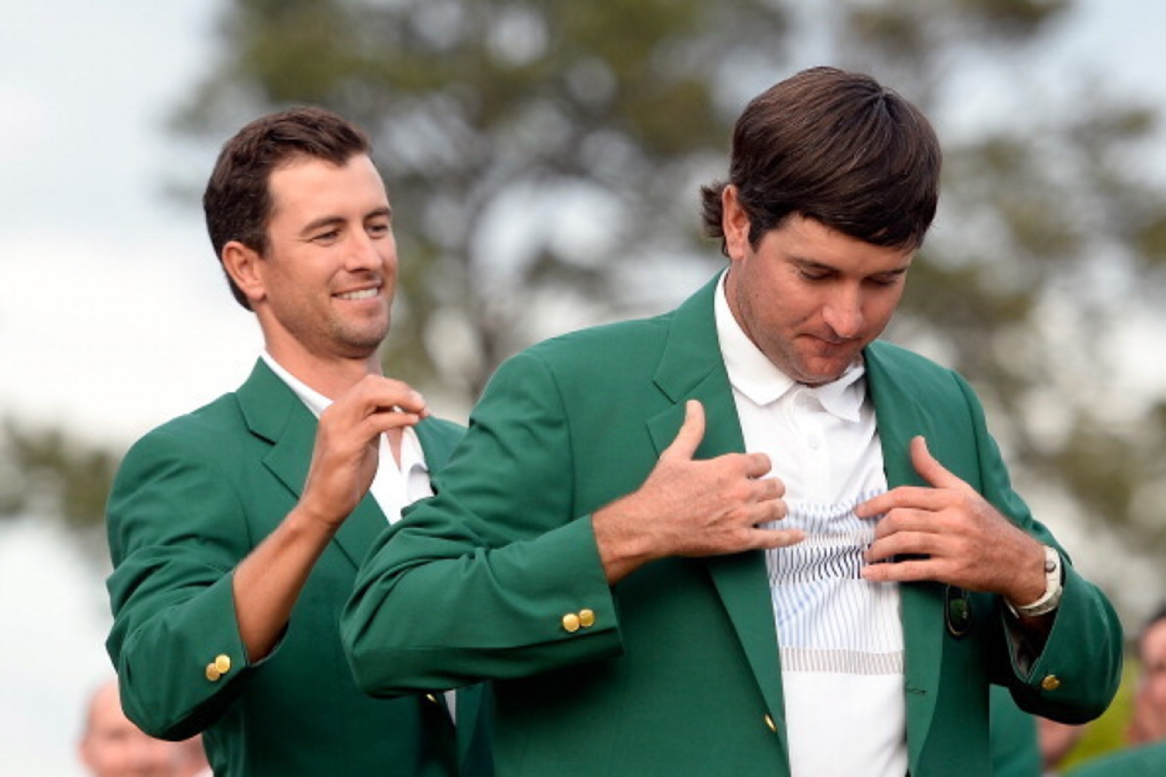 AUGUSTA, GA - APRIL 13: Adam Scott of Australia presents Bubba Watson of the United States with the green jacket after Watson won the 2014 Masters Tournament by a three-stroke margin at Augusta National Golf Club on April 13, 2014 in Augusta, Georgia. ( AUGUSTA, GA - APRIL 13: Adam Scott of Australia presents Bubba Watson of the United States with the green jacket after Watson won the 2014 Masters Tournament by a three-stroke margin at Augusta National Golf Club on April 13, 2014 in Augusta, Georgia. (