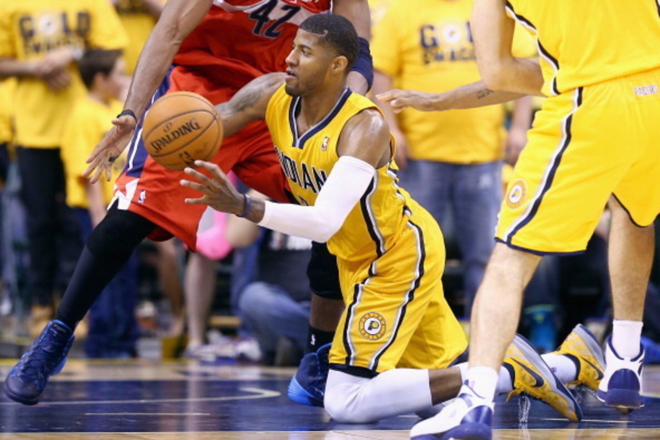 INDIANAPOLIS, IN - MAY 05:  Paul George #24 of the Indiana Pacers passes the ball while defended by Nene #42 of the Washington Wizards in Game 1 of the Eastern Conference Semifinals during the 2014 NBA Playoffs at Bankers Life Fieldhouse on May 5, 2014 in
