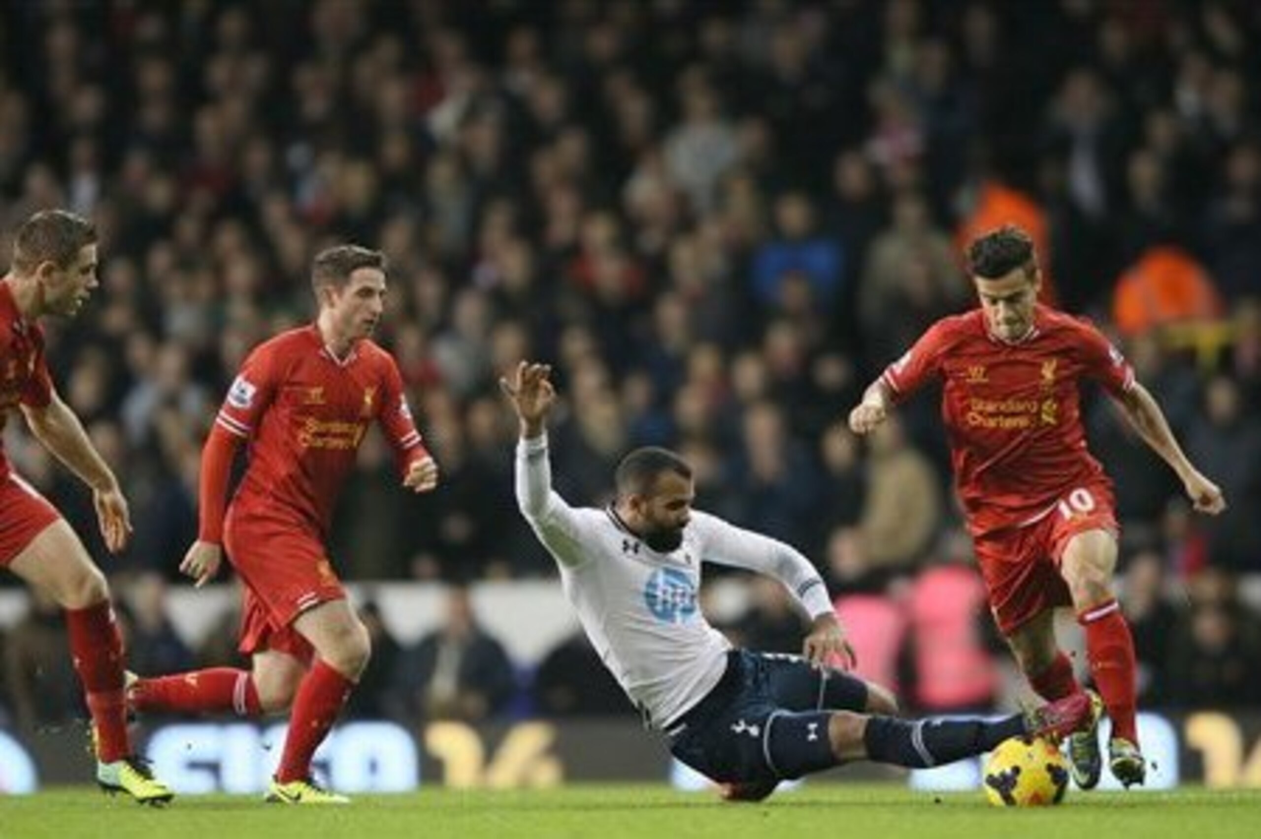 In what proved to be his final game of 2013, Sandro tackles his fellow Brazilian, Liverpool attacker Philippe Coutinho.