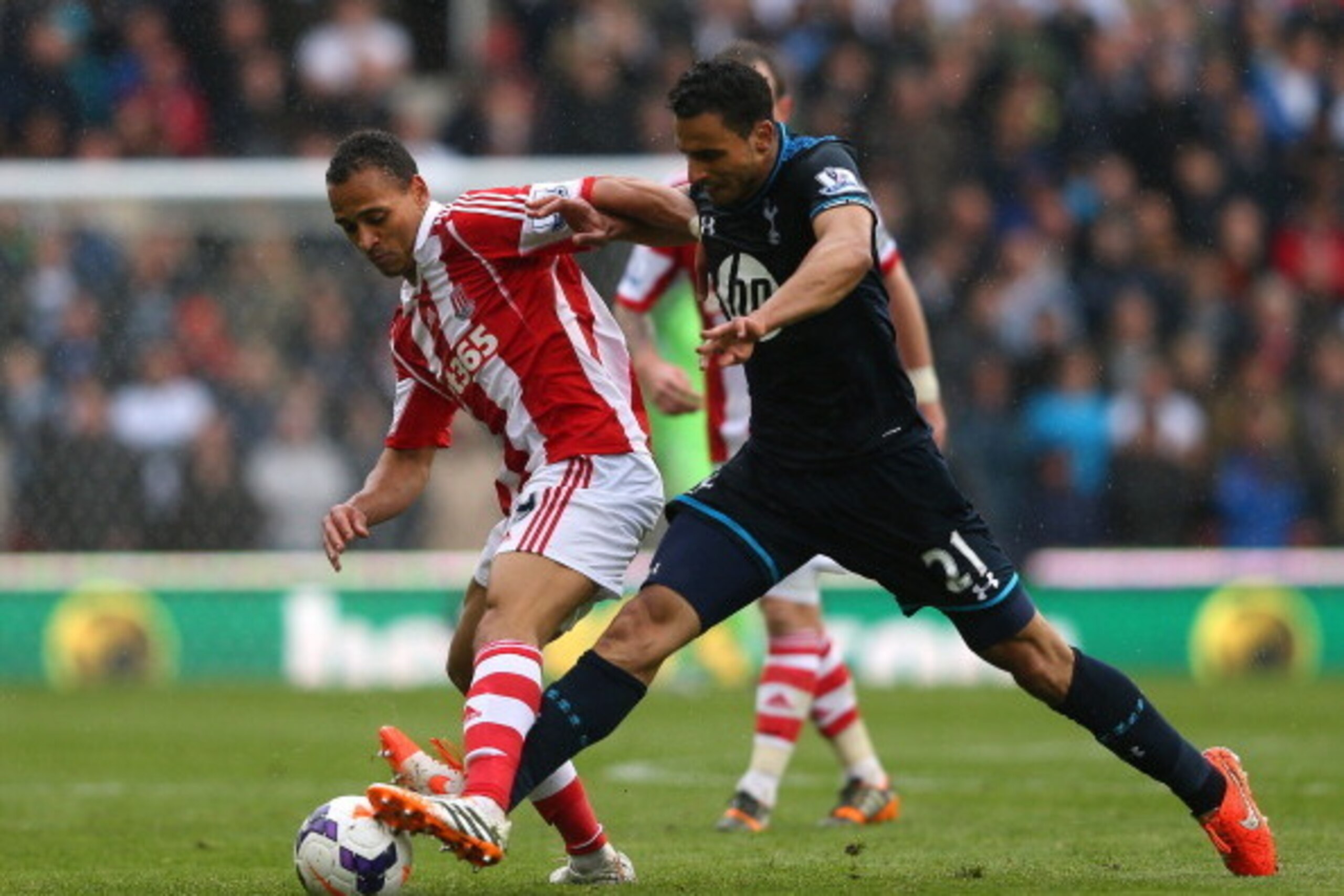 STOKE ON TRENT, ENGLAND - APRIL 26:  Peter Odemwingie of Stoke City is tackled by Nacer Chadli of Tottenham Hotspur during the Barclays Premier League match between Stoke City and Tottenham Hotspur at the Britannia Stadium on April 26, 2014 in Stoke on Tr