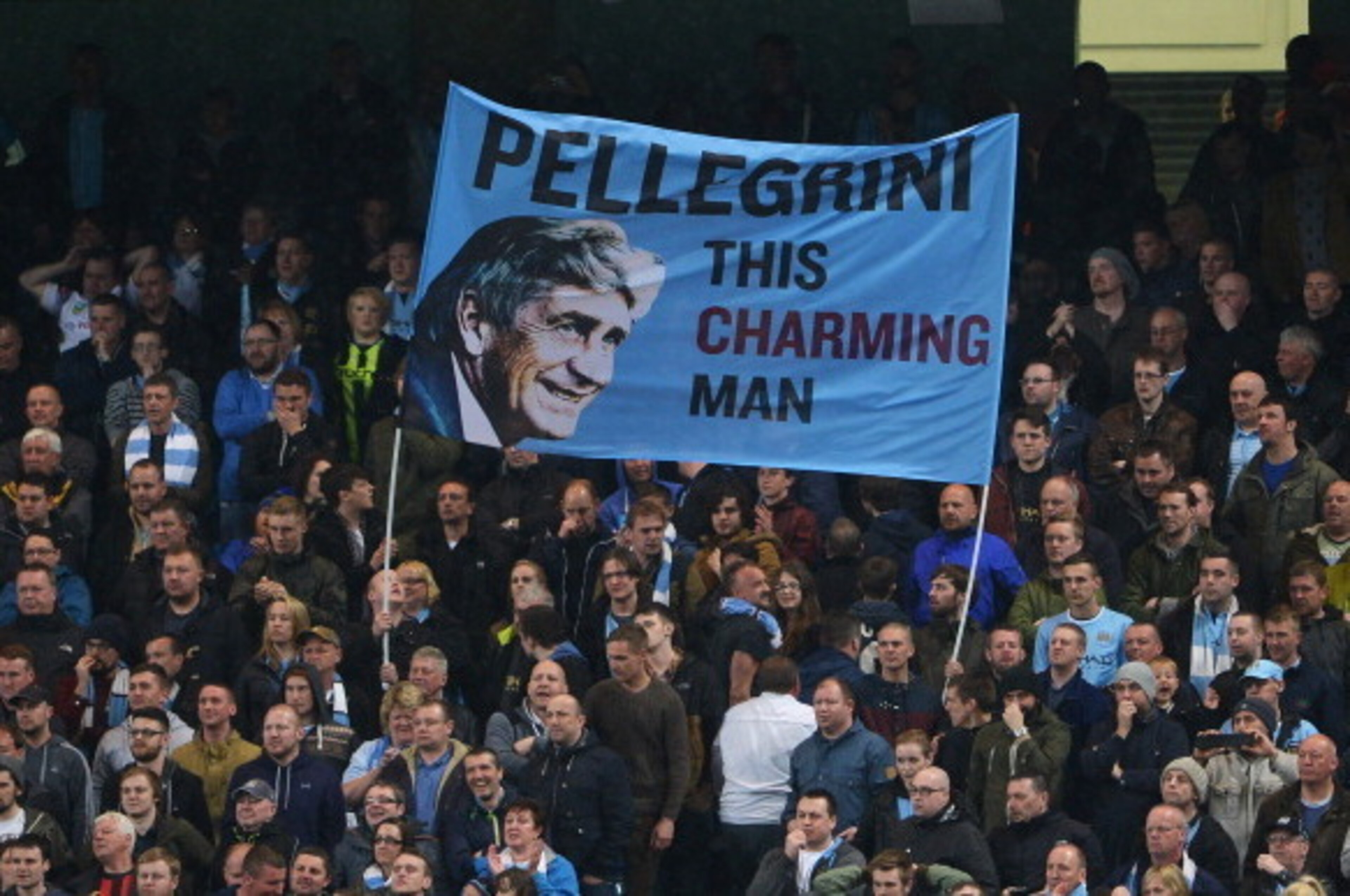 MANCHESTER, ENGLAND - MAY 07: Manchester City fans fly a flag for Manuel Pellegrini, manager of Manchester City during the Barclays Premier League match between Manchester City and Aston Villa at Etihad Stadium on May 7, 2014 in Manchester, England.  (Pho
