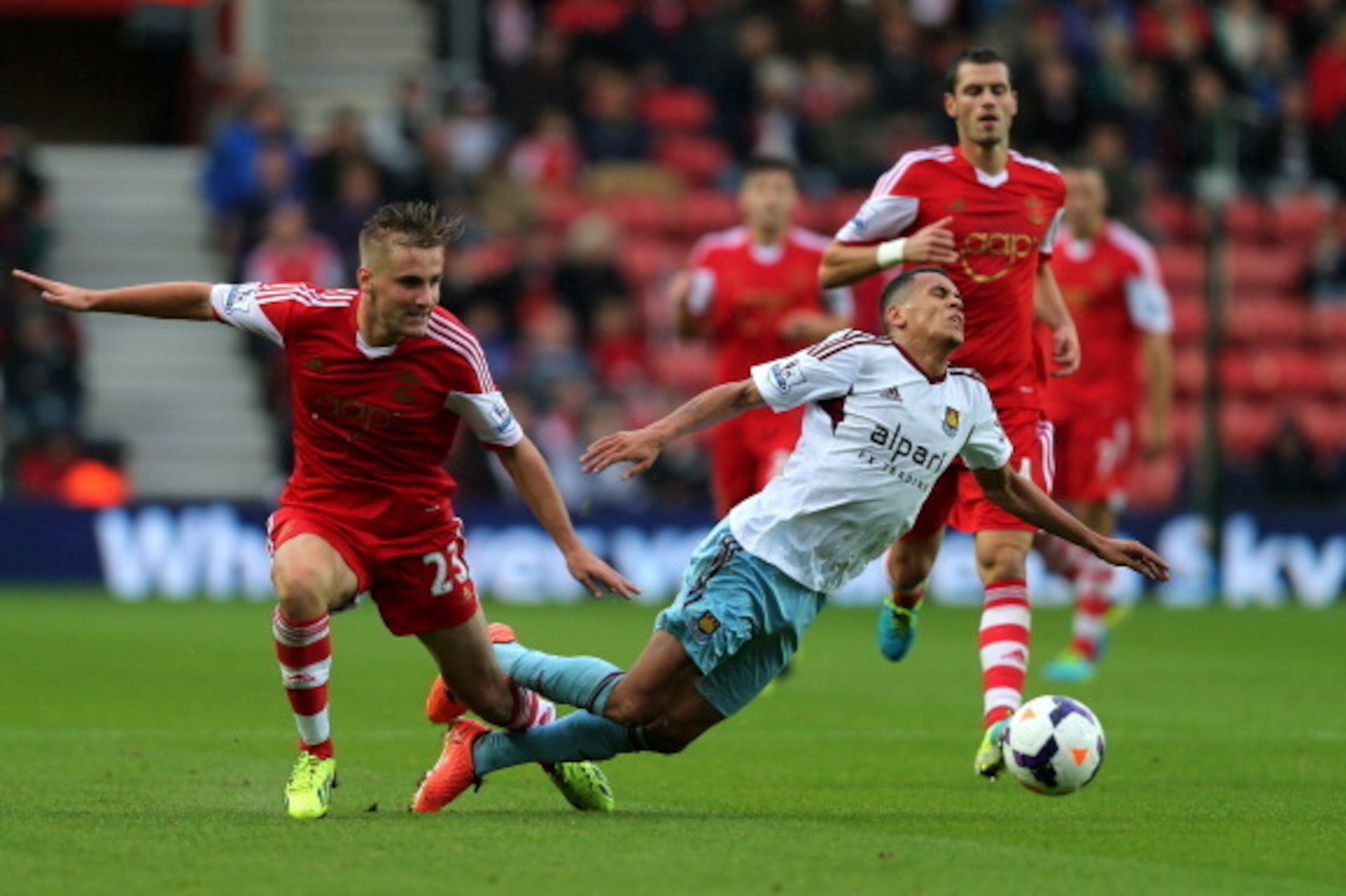 SOUTHAMPTON, ENGLAND - SEPTEMBER 15:   Ravel Morrison of West Ham is brought down  by Luke Shaw of Southampton during the Barclays Premier League match between Southampton and West Ham United at St Mary's Stadium on September 15, 2013 in Southampton, Engl