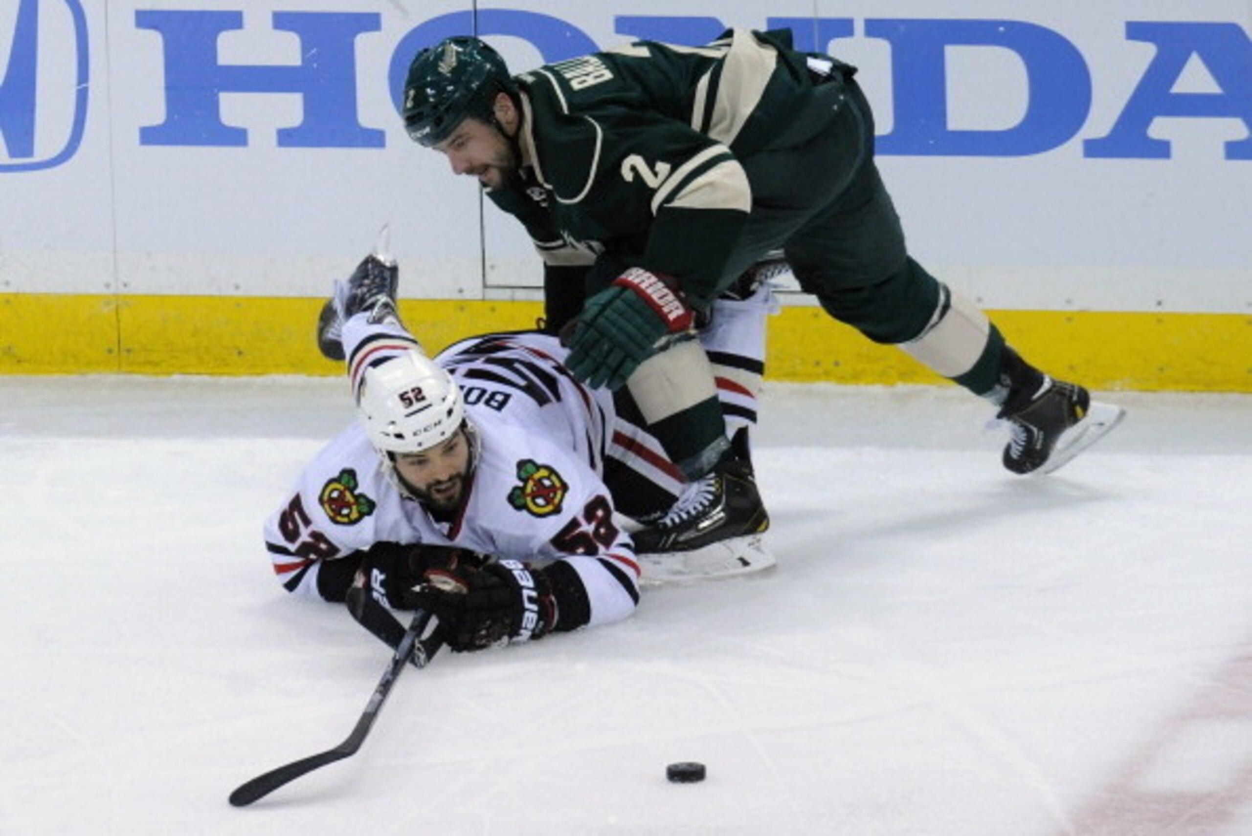 ST PAUL, MN - MAY 6: Brandon Bollig #52 of the Chicago Blackhawks and Keith Ballard #2 of the Minnesota Wild watch the puck during the third period in Game Three of the Second Round of the 2014 NHL Stanley Cup Playoffs on May 6, 2014 at Xcel Energy Center