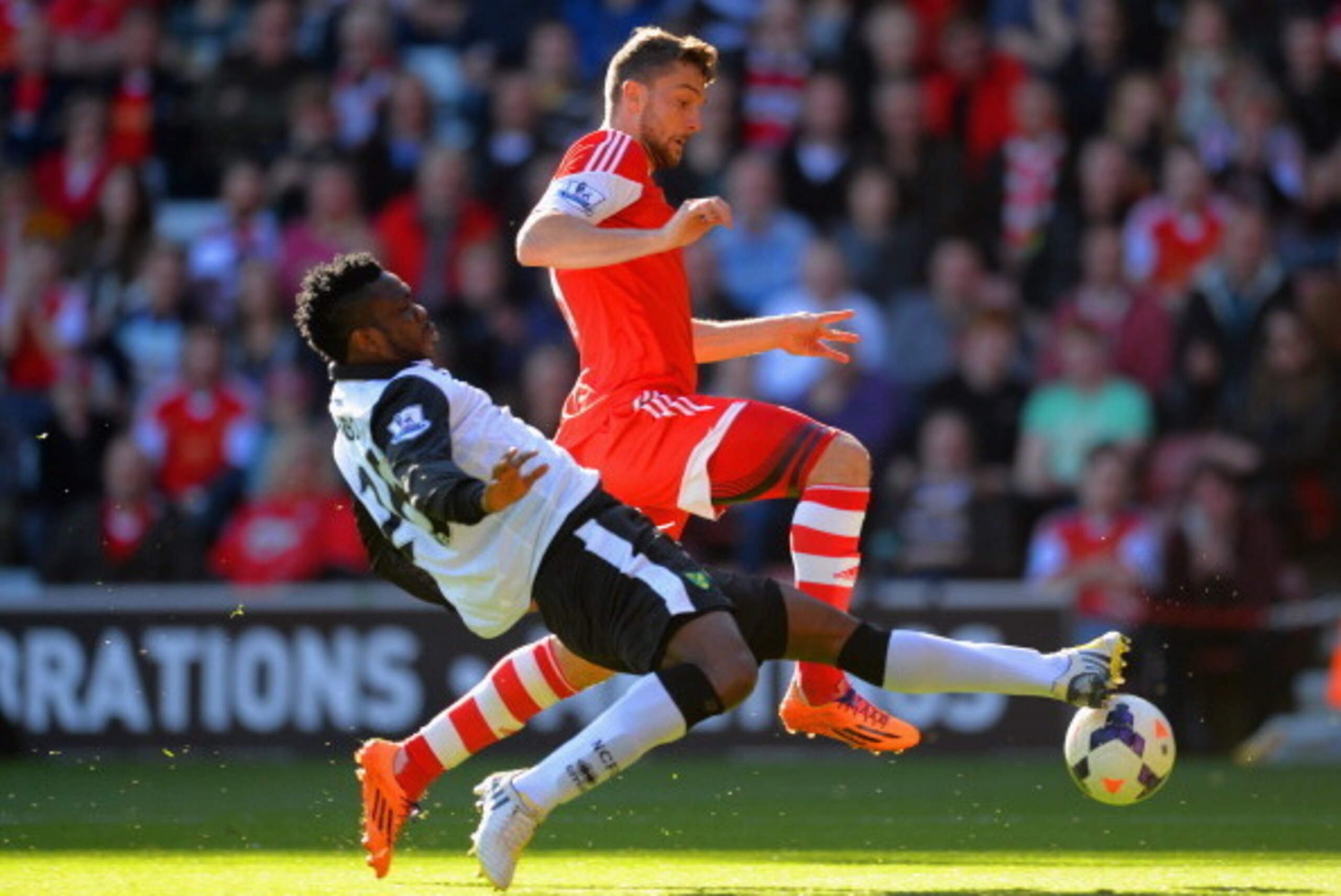 SOUTHAMPTON, ENGLAND - MARCH 15:  Daniel Sanchez Ayala of Norwich City tackles Morgan Schneiderlin of Southampton during the Barclays Premier League match between Southampton and Norwich City at St Mary's Stadium on March 15, 2014 in Southampton, England.
