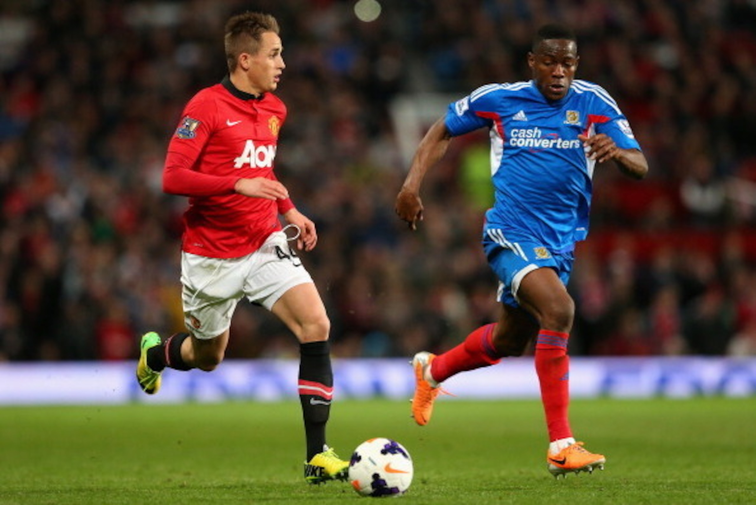 MANCHESTER, ENGLAND - MAY 06:  Adnan Januzaj of Manchester United competes with Maynor Figueroa of Hull City during the Barclays Premier League match between Manchester United and Hull City at Old Trafford on May 6, 2014 in Manchester, England.  (Photo by