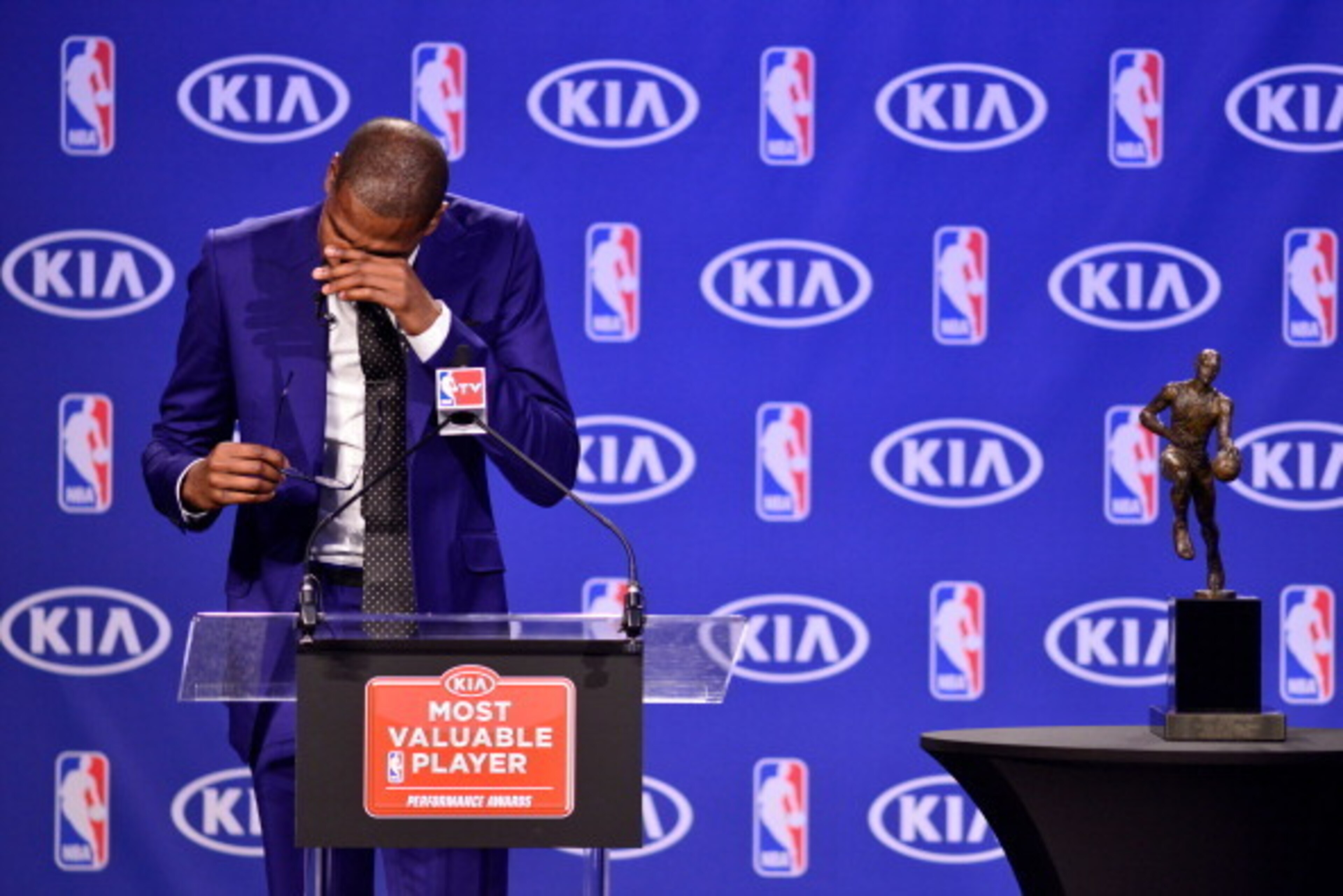 EDMOND, OK - MAY 06:  Kevin Durant of the Oklahoma City Thunder shows emotion after receiving the Maurice Podoloff Trophy for the 2013-14 KIA Player of the Year award during a press conference on May 6, 2014 at the Thunder Events Center in Edmond, Oklahom