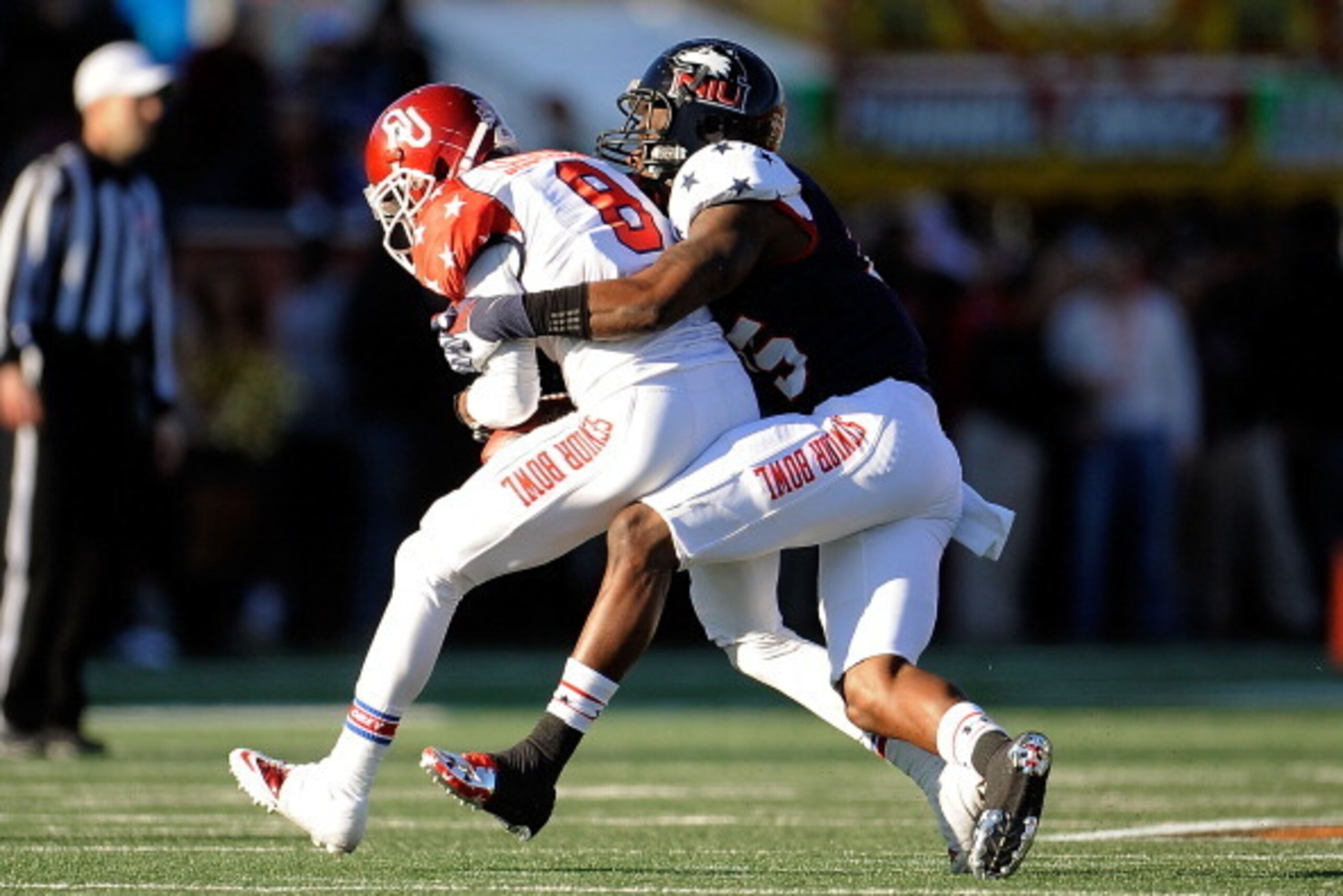 MOBILE, AL - JANUARY 25:  Jalen Saunders #8 of the South squad catches a pass in front of Jimmie Ward #15 of the North squad during the Reese's Senior Bowl at Ladd-Peebles Stadium on January 25, 2014 in Mobile, Alabama.  The South defeated the North 20-10