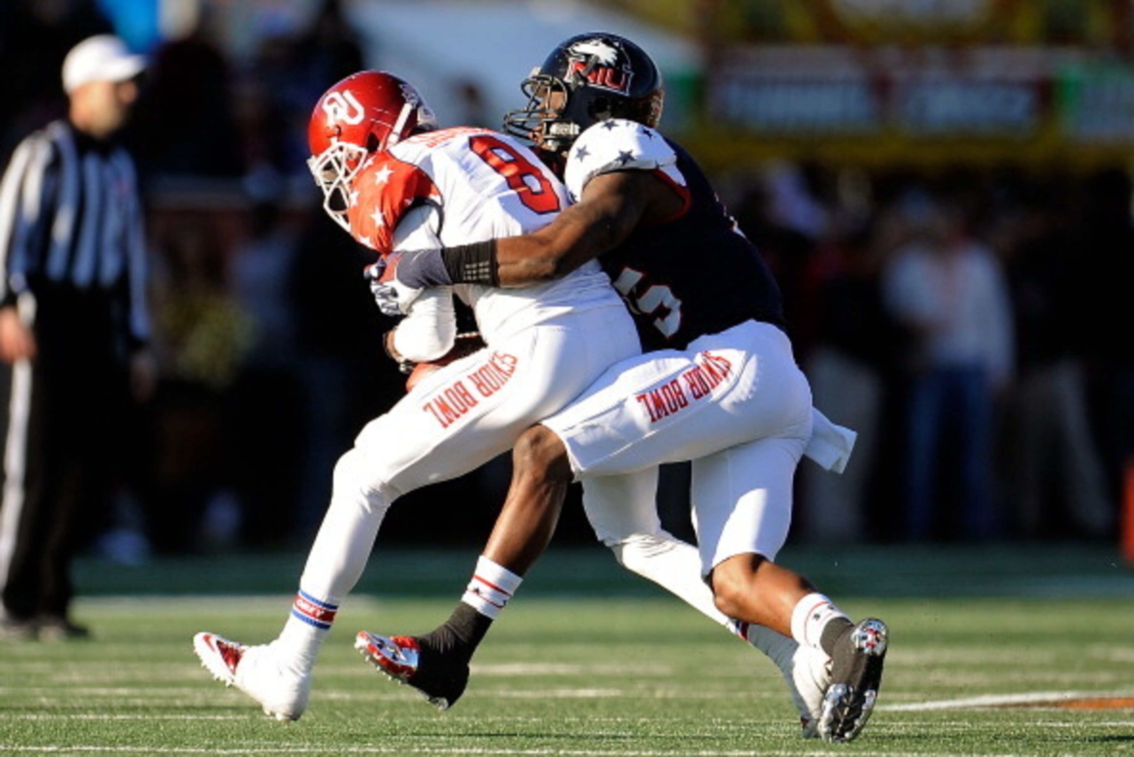 MOBILE, AL - JANUARY 25:  Jalen Saunders #8 of the South squad catches a pass in front of Jimmie Ward #15 of the North squad during the Reese's Senior Bowl at Ladd-Peebles Stadium on January 25, 2014 in Mobile, Alabama.  The South defeated the North 20-10