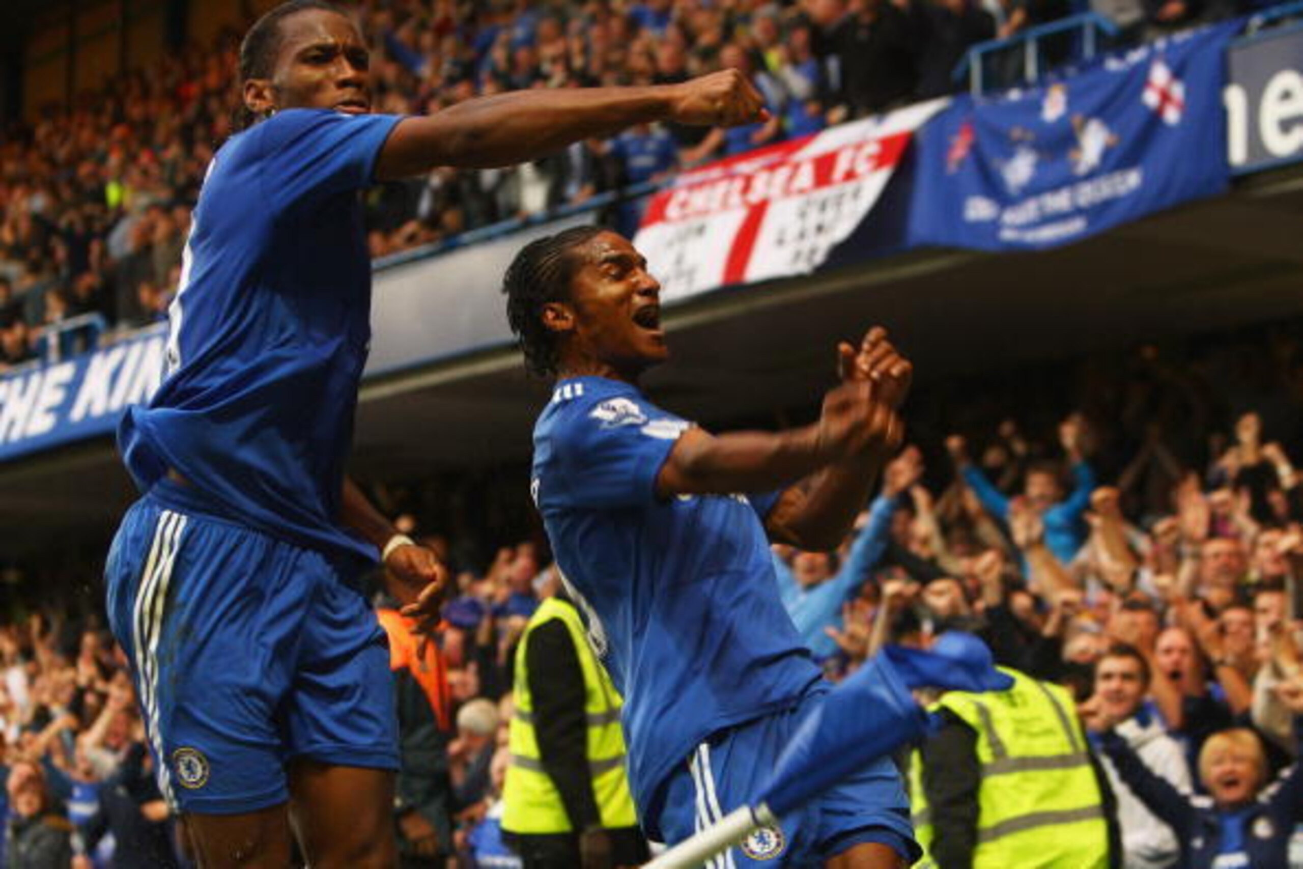 LONDON - OCTOBER 04:  Florent Malouda of Chelsea (R) celebrates with team mate Didier Drogba as he scores their second goal during the Barclays Premier League match between Chelsea and Liverpool at Stamford Bridge on October 4, 2009 in London, England.  (