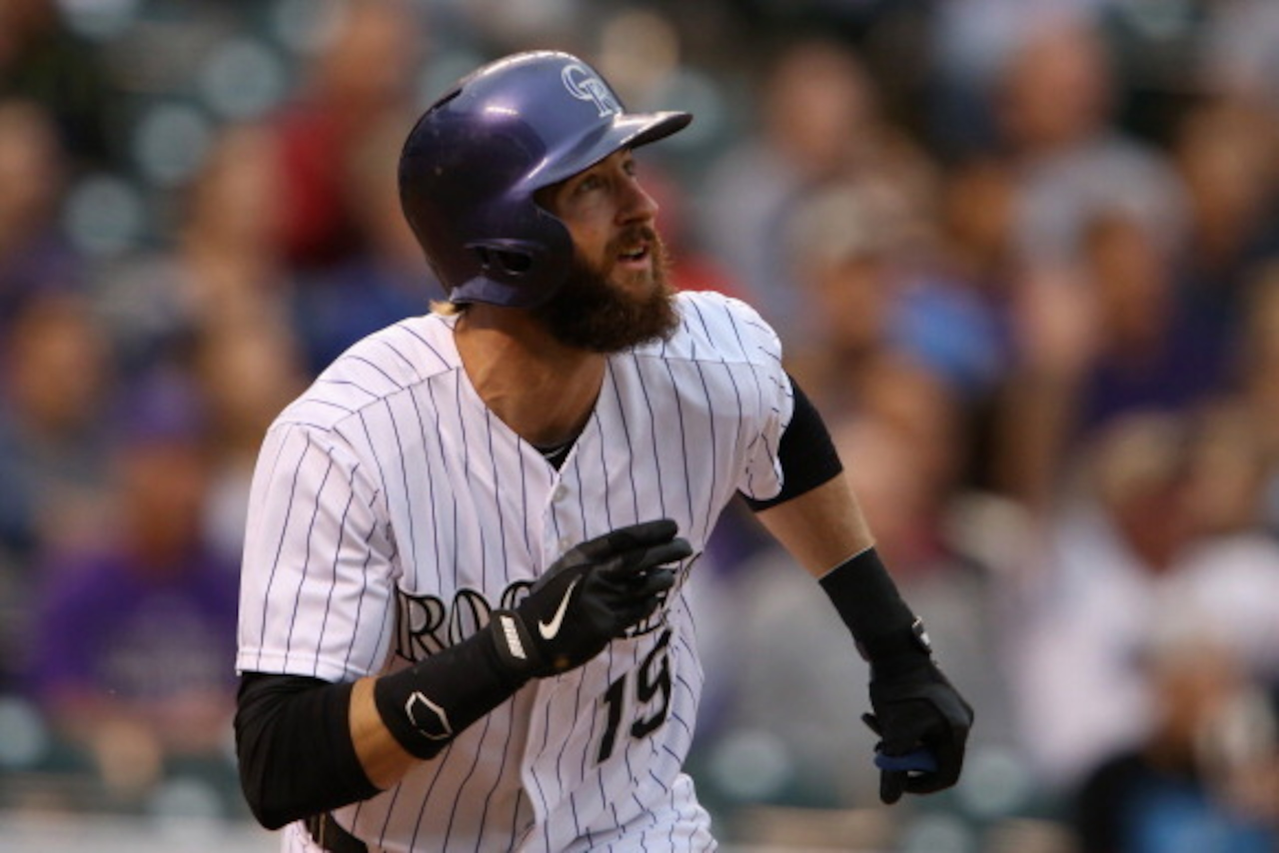 DENVER, CO - MAY 06:  Charlie Blackmon #19 of the Colorado Rockies watches his solo home run off of starting pitcher Robbie Ross Jr. #46 of the Texas Rangers to tie the score 1-1 in the first inning during Interleague play at Coors Field on May 6, 2014 in