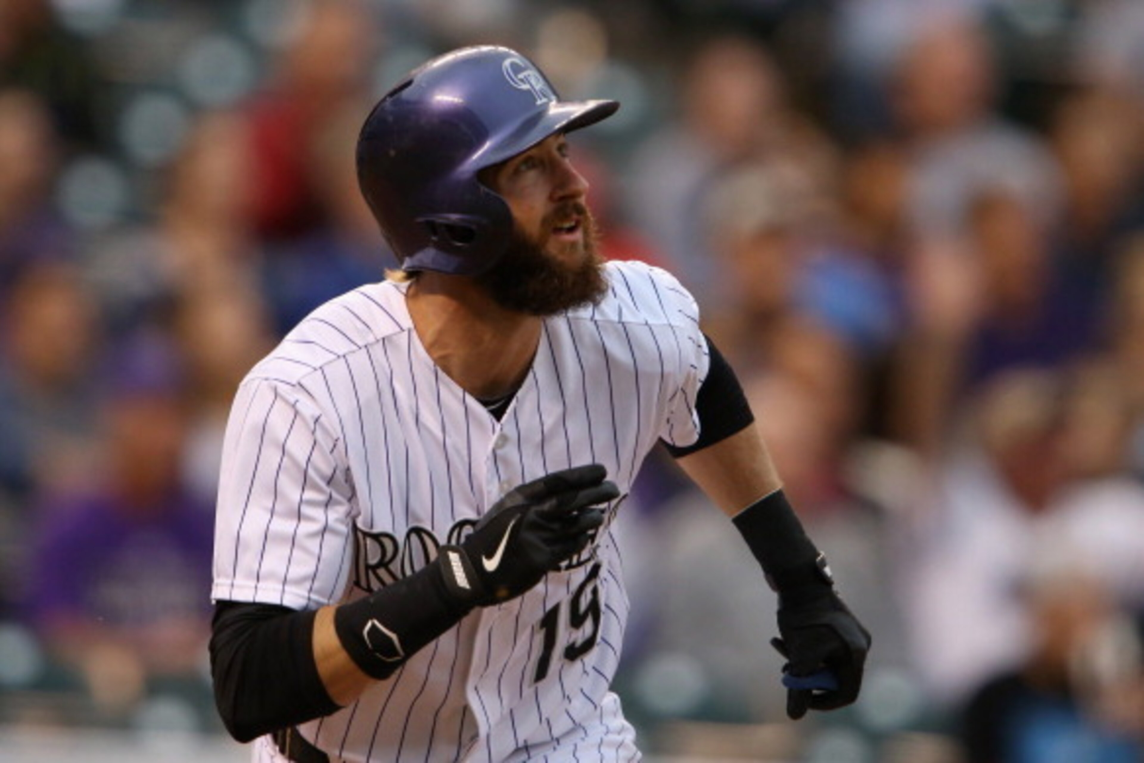 DENVER, CO - MAY 06:  Charlie Blackmon #19 of the Colorado Rockies watches his solo home run off of starting pitcher Robbie Ross Jr. #46 of the Texas Rangers to tie the score 1-1 in the first inning during Interleague play at Coors Field on May 6, 2014 in