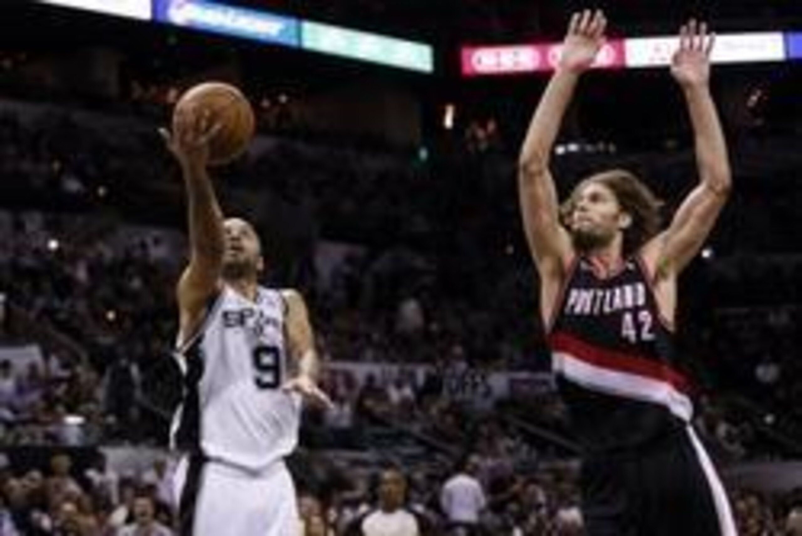 May 6, 2014; San Antonio, TX, USA; San Antonio Spurs guard Tony Parker (9) drives to the basket under pressure from Portland Trail Blazers center Robin Lopez (42) in game one of the second round of the 2014 NBA Playoffs at AT&T Center. Mandatory Credit: S