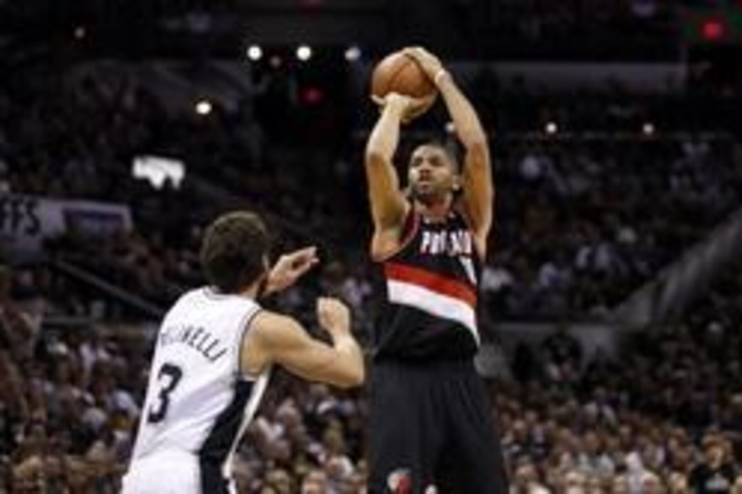 May 6, 2014; San Antonio, TX, USA; Portland Trail Blazers forward Nicolas Batum (88) shoots the ball over San Antonio Spurs forward Marco Belinelli (3) in game one of the second round of the 2014 NBA Playoffs at AT&T Center. Mandatory Credit: Soobum Im-US