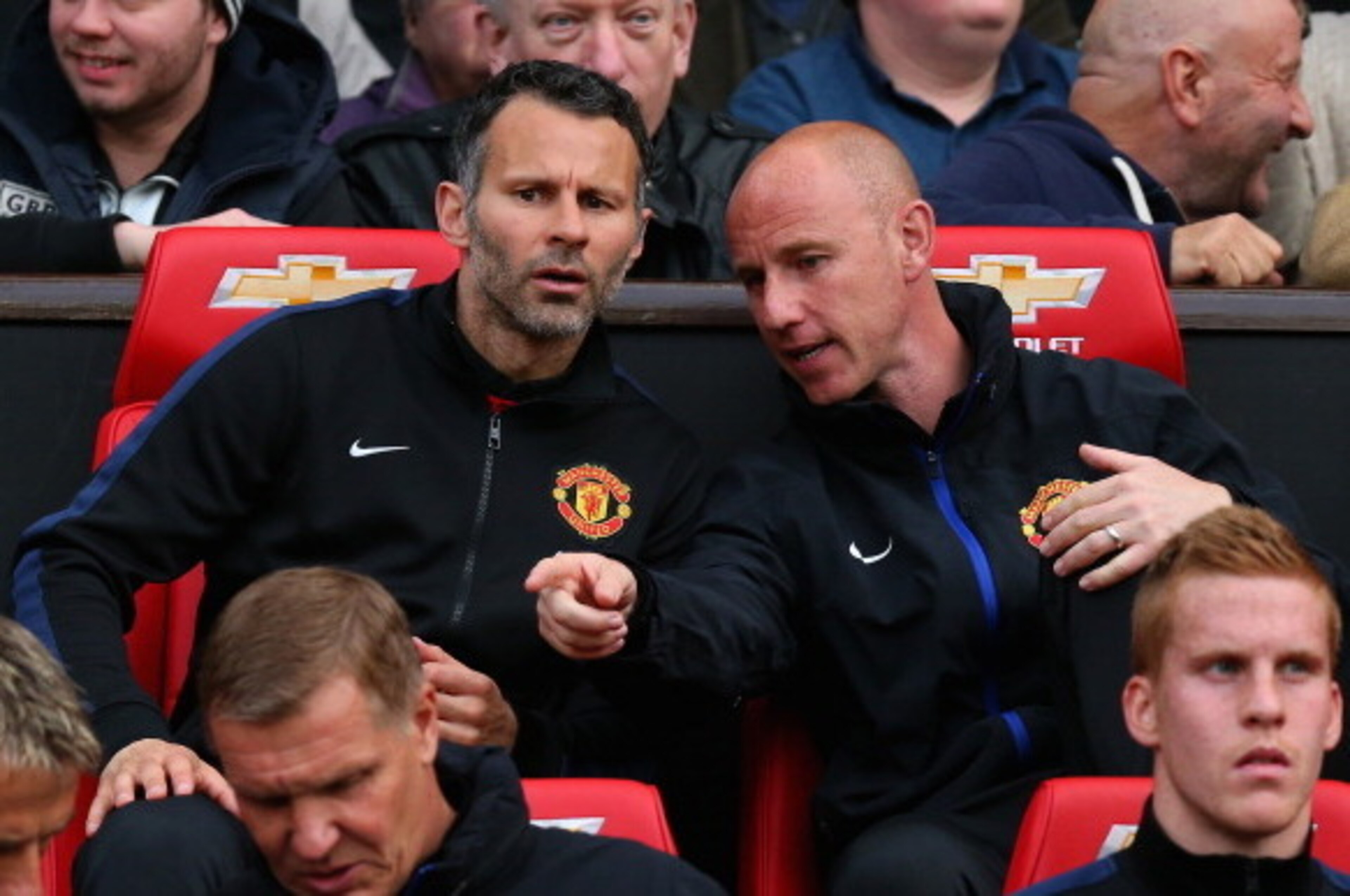 MANCHESTER, ENGLAND - MAY 06: Manchester United Caretaker Manager Ryan Giggs speaks with Nicky Butt (R) prior to the Barclays Premier League match between Manchester United and Hull City at Old Trafford on May 6, 2014 in Manchester, England. (Photo by A MANCHESTER, ENGLAND - MAY 06: Manchester United Caretaker Manager Ryan Giggs speaks with Nicky Butt (R) prior to the Barclays Premier League match between Manchester United and Hull City at Old Trafford on May 6, 2014 in Manchester, England. (Photo by A