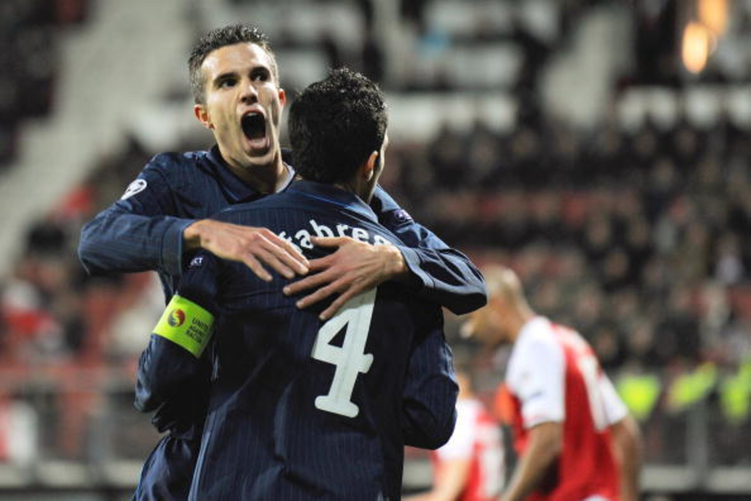 ALKMAAR, NETHERLANDS - OCTOBER 20: Cesc Fabregas of Arsenal celebrates with Robin van Persie after scoring the first goal during the UEFA Champions League Group H match between AZ Alkmaar and Arsenal at the DSB Stadium on October 20, 2009 in Alkmaar, Neth