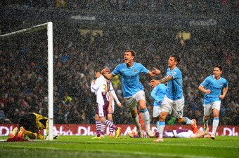 MANCHESTER, ENGLAND - MAY 07:  Edin Dzeko of Manchester City celebrates scoring the opening goal during the Barclays Premier League match between Manchester City and Aston Villa at Etihad Stadium on May 7, 2014 in Manchester, England.  (Photo by Michael R