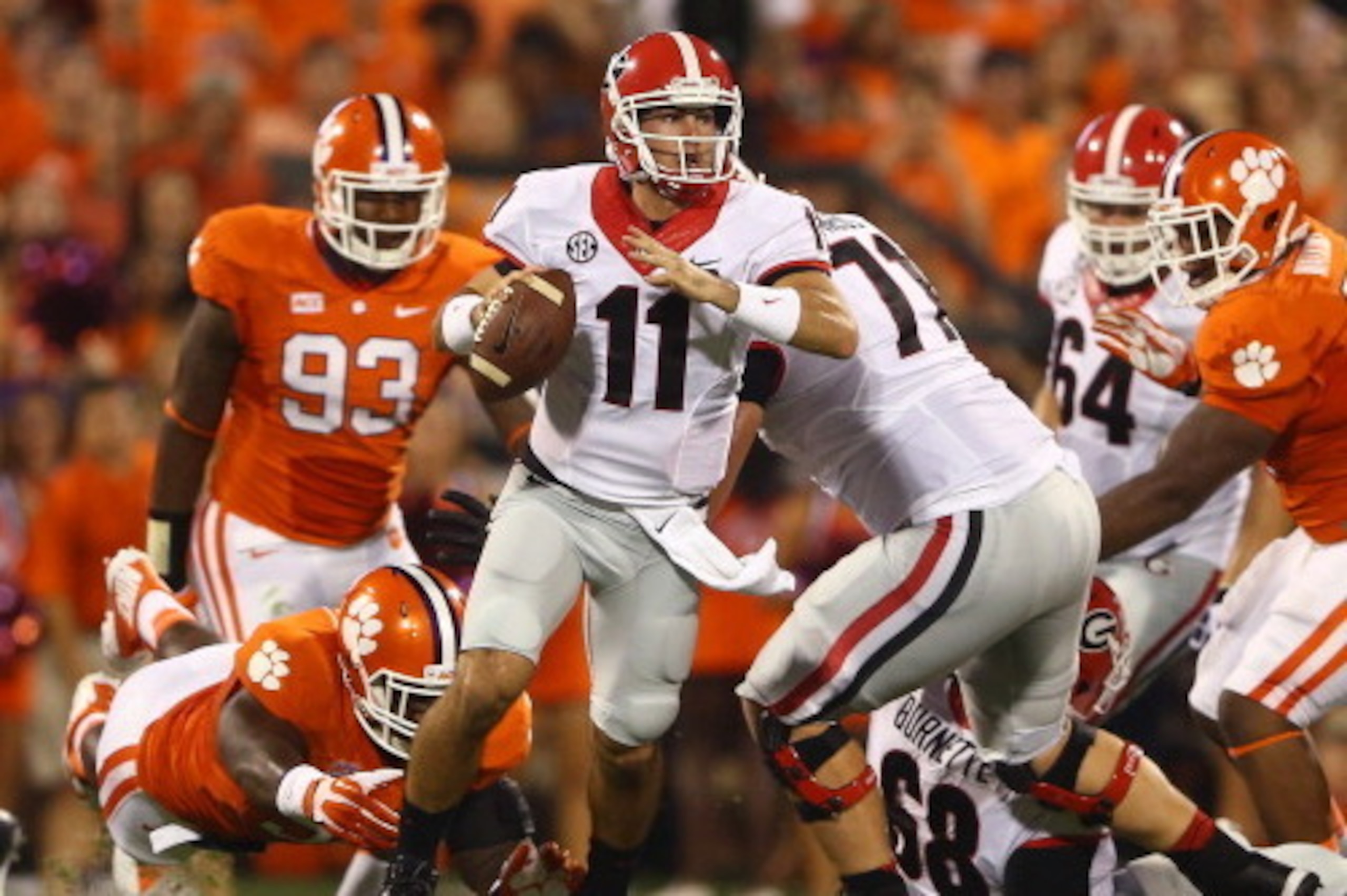 CLEMSON, SC - AUGUST 31: Aaron Murray #11 of the Georgia Bulldogs looks to pass while avoiding being tackled by Grady Jarrett #50 of the Clemson Tigers in the first quarter at Memorial Stadium on August 31, 2013 in Clemson, South Carolina. (Photo by Str CLEMSON, SC - AUGUST 31: Aaron Murray #11 of the Georgia Bulldogs looks to pass while avoiding being tackled by Grady Jarrett #50 of the Clemson Tigers in the first quarter at Memorial Stadium on August 31, 2013 in Clemson, South Carolina. (Photo by Str