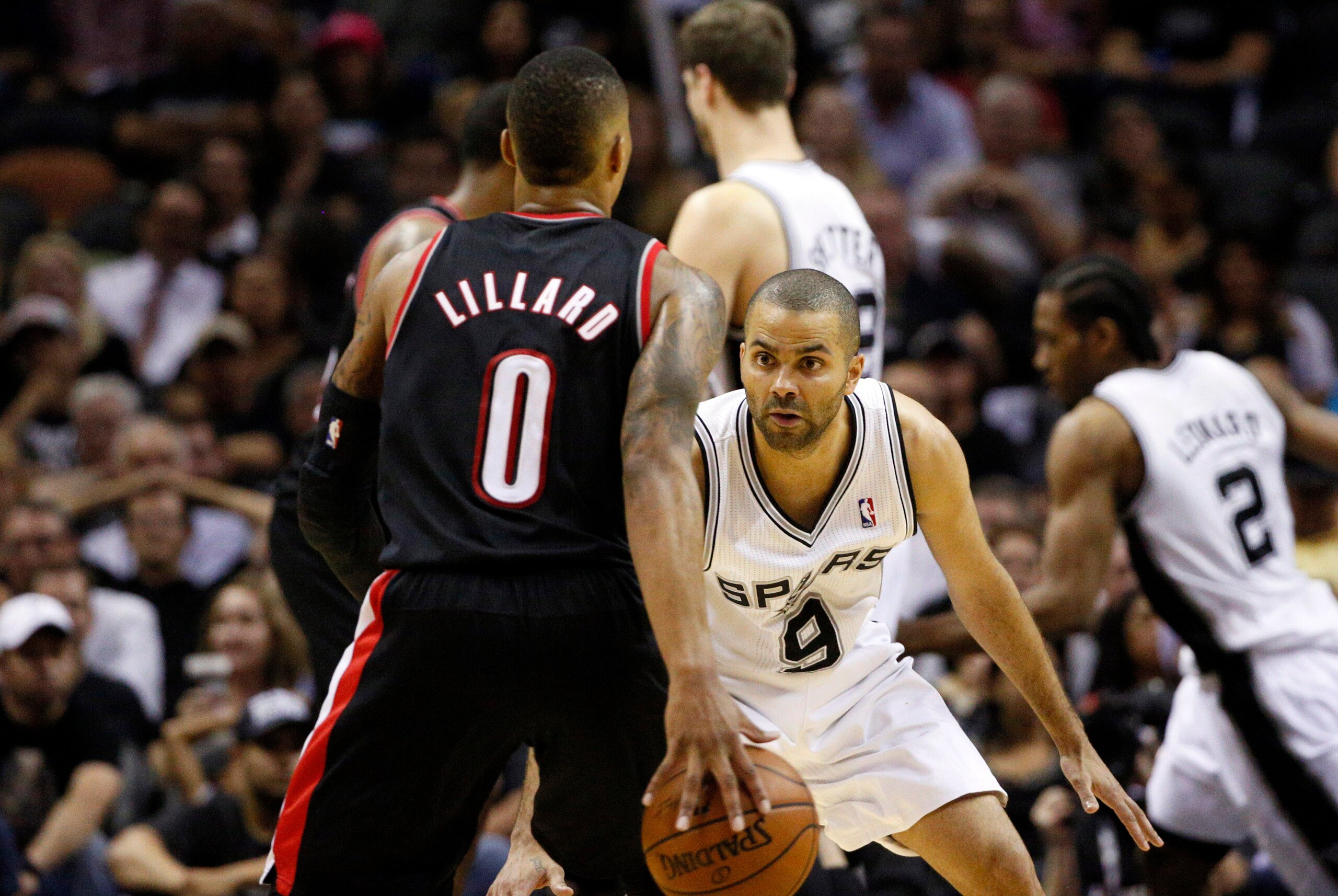 May 6, 2014; San Antonio, TX, USA; Portland Trail Blazers guard Damian Lillard (0) is defended by San Antonio Spurs guard Tony Parker (9) in game one of the second round of the 2014 NBA Playoffs at AT&T Center. The Spurs won 116-92. Mandatory Credit: Soob May 6, 2014; San Antonio, TX, USA; Portland Trail Blazers guard Damian Lillard (0) is defended by San Antonio Spurs guard Tony Parker (9) in game one of the second round of the 2014 NBA Playoffs at AT&T Center. The Spurs won 116-92. Mandatory Credit: Soob