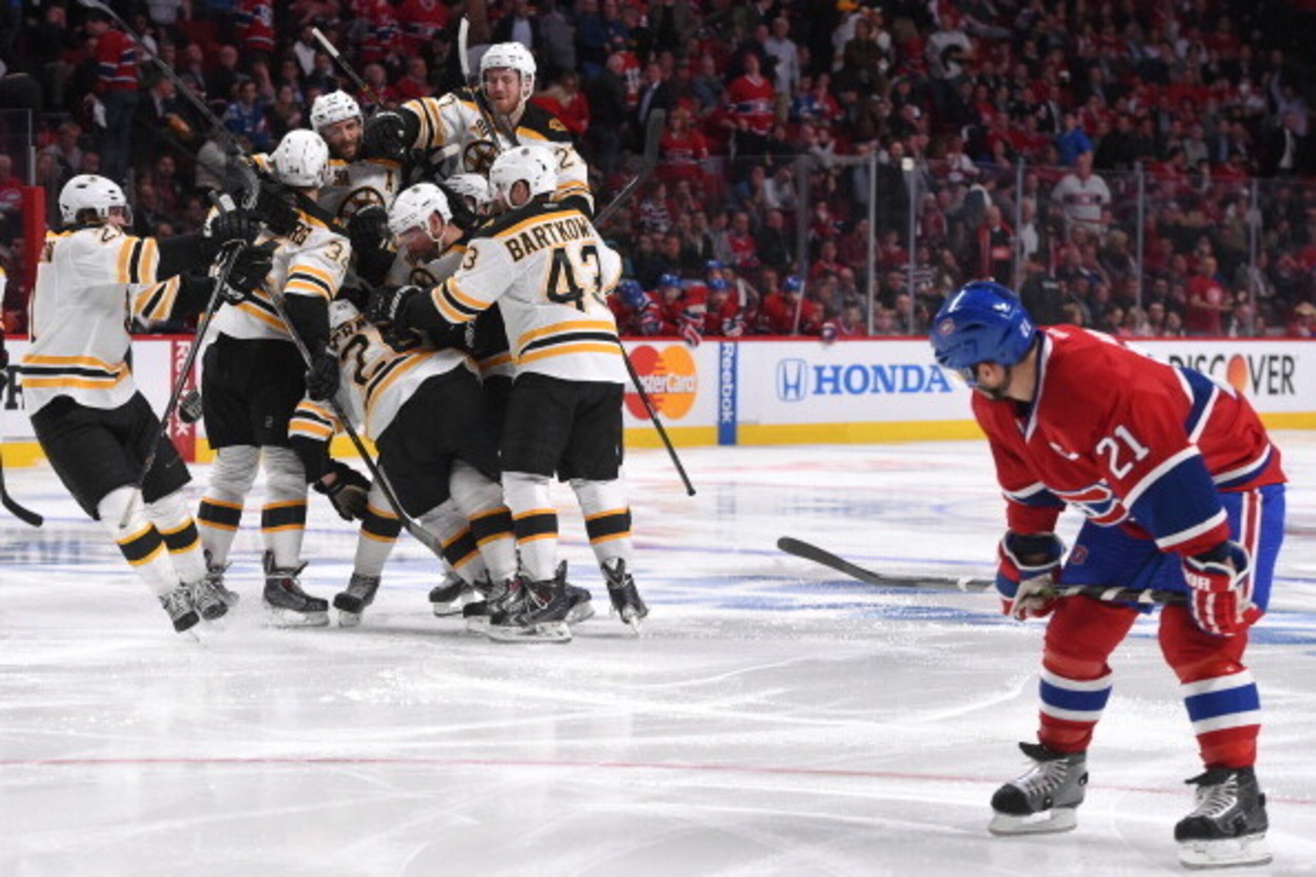 MONTREAL, QC - MAY 8: Brian Gionta #21of the Montreal Canadiens watches Matt Fraser #25 of the Boston Bruins celebrate with teammates Matt Bartkowski #43, Dougie Hamilton #27, Carl Soderberg #34  and others after scoring the winning goal against in Game F