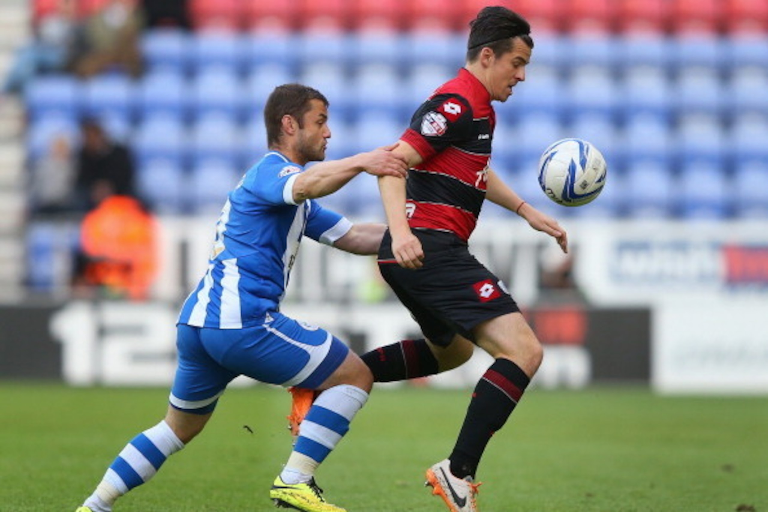 WIGAN, ENGLAND - MAY 09:  Joey Barton of Queens Park Rangers shields the ball from Shaun Maloney of Wigan Athletic during the Sky Bet Championship Play Off Semi Final first leg match between Wigan Athletic and Queens Park Rangers at DW Stadium on May 9, 2