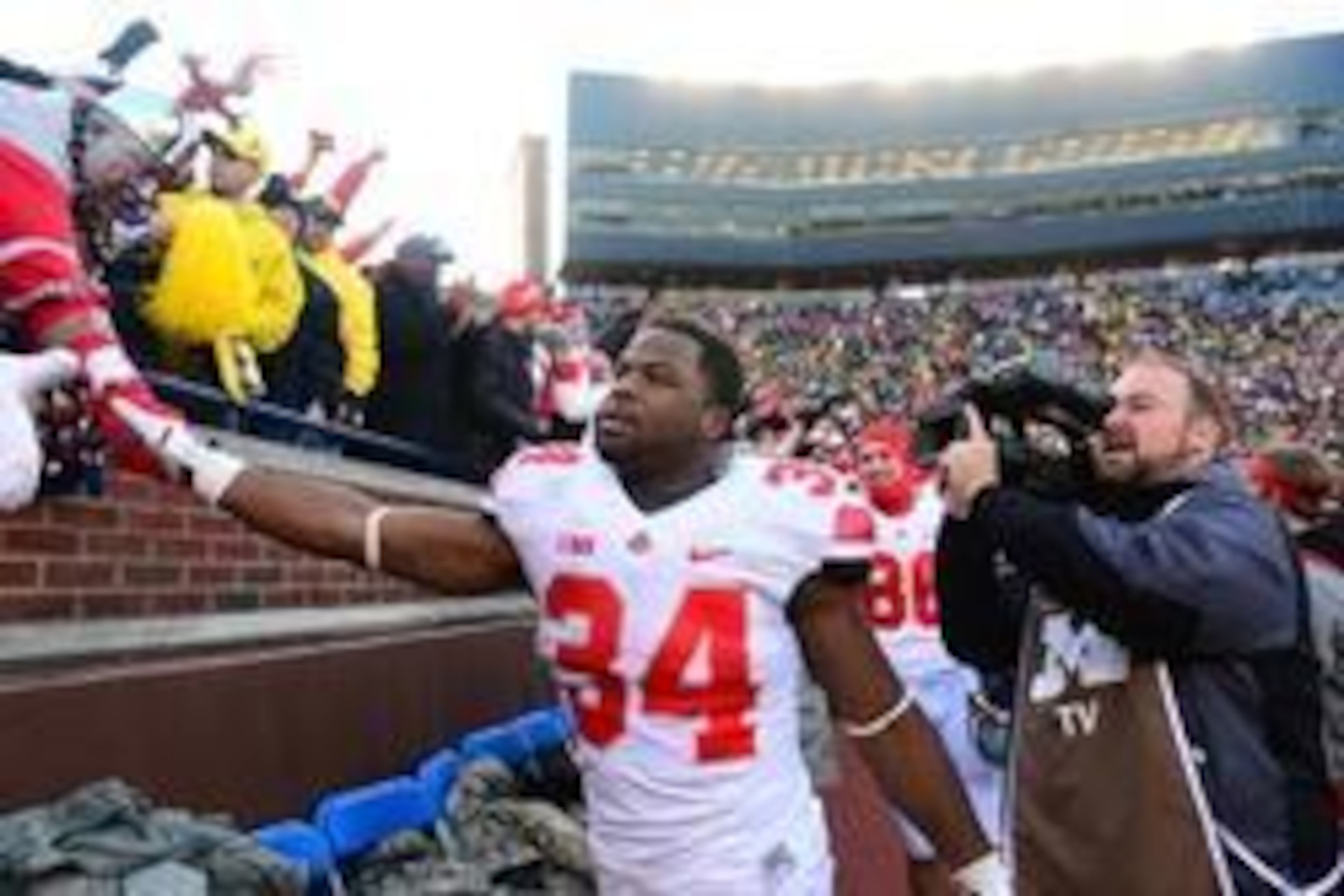 Nov 30, 2013; Ann Arbor, MI, USA; Ohio State Buckeyes running back Carlos Hyde (34) celebrates with fans after defeating Michigan Wolverines 42-41 at Michigan Stadium. Mandatory Credit: Andrew Weber-USA TODAY Sports Nov 30, 2013; Ann Arbor, MI, USA; Ohio State Buckeyes running back Carlos Hyde (34) celebrates with fans after defeating Michigan Wolverines 42-41 at Michigan Stadium. Mandatory Credit: Andrew Weber-USA TODAY Sports