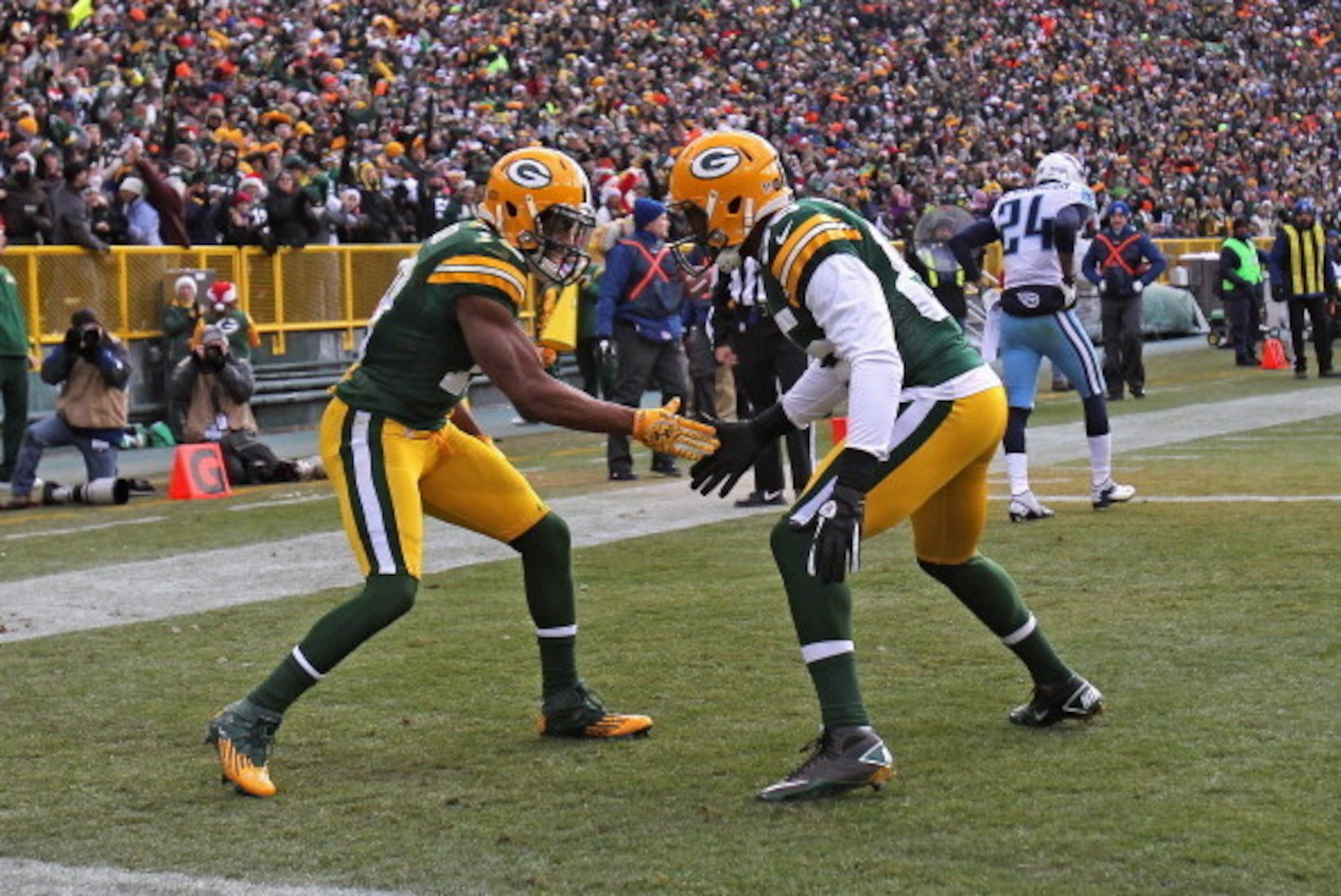 GREEN BAY, WI - DECEMBER 23: Randall Cobb #18 of the Green Bay Packers (L) celebrates a touchdown catch with Greg Jennings #85 against the Tennessee Titans at Lambeau Field on December 23, 2012 in Green Bay, Wisconsin. The Packers defeated the Titans 55-7