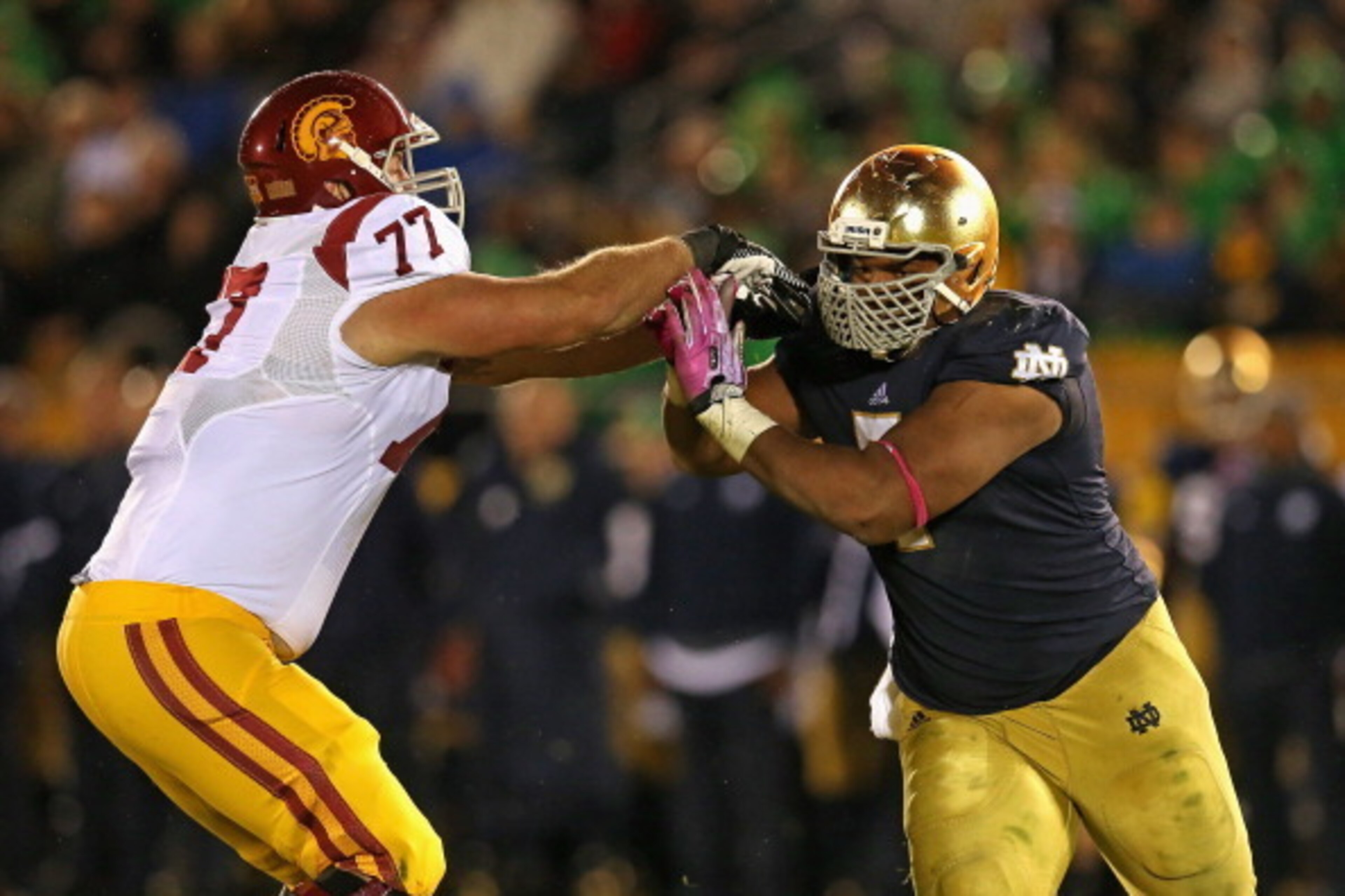 SOUTH BEND, IN - OCTOBER 19: Stephon Tuitt #7 of the Notre Dame Fighting Irish rushes against Kevin Graf #77 of the University of Southern California Trojans at Notre Dame Stadium on October 19, 2013 in South Bend, Indiana. Notre Dame defeated USC 14-10. 