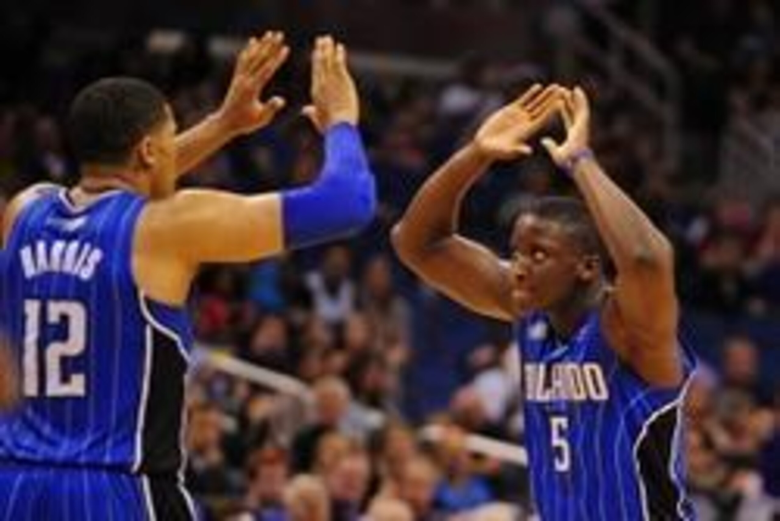Mar 28, 2014; Orlando, FL, USA; Orlando Magic guard Victor Oladipo (5) and forward Tobias Harris (12) celebrate after Harris drew a foul in overtime as the Magic beat the Charlotte Bobcats 110-105 at Amway Center. Mandatory Credit: David Manning-USA TODAY