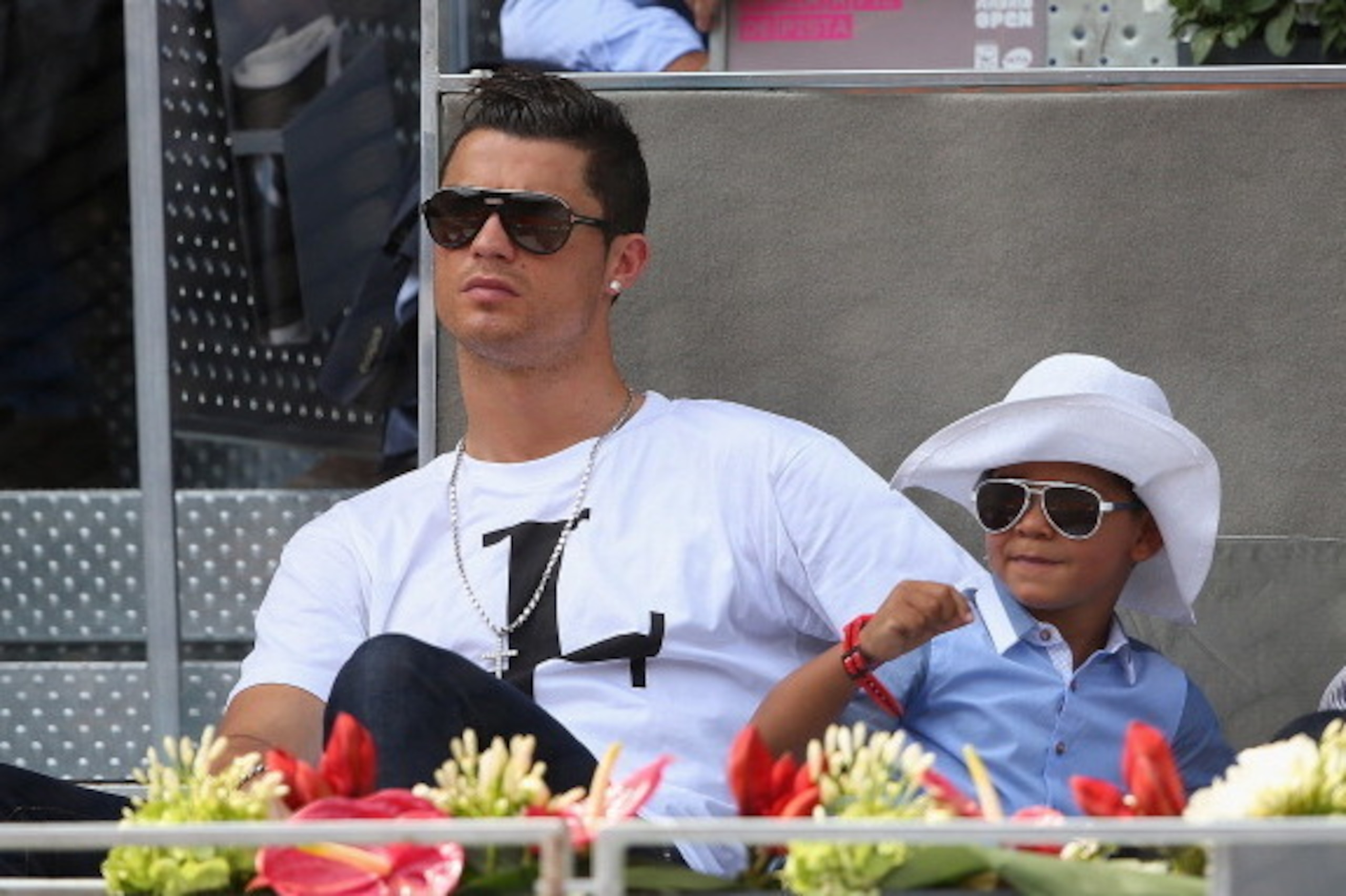 MADRID, SPAIN - MAY 08:  Real Madrid footballer Cristiano Ronaldo and his son Cristiano Ronaldo Junior watch Rafael Nadal of Spain against Jarkko Nieminen of Finland in their third round match during day six of the Mutua Madrid Open tennis tournament at t