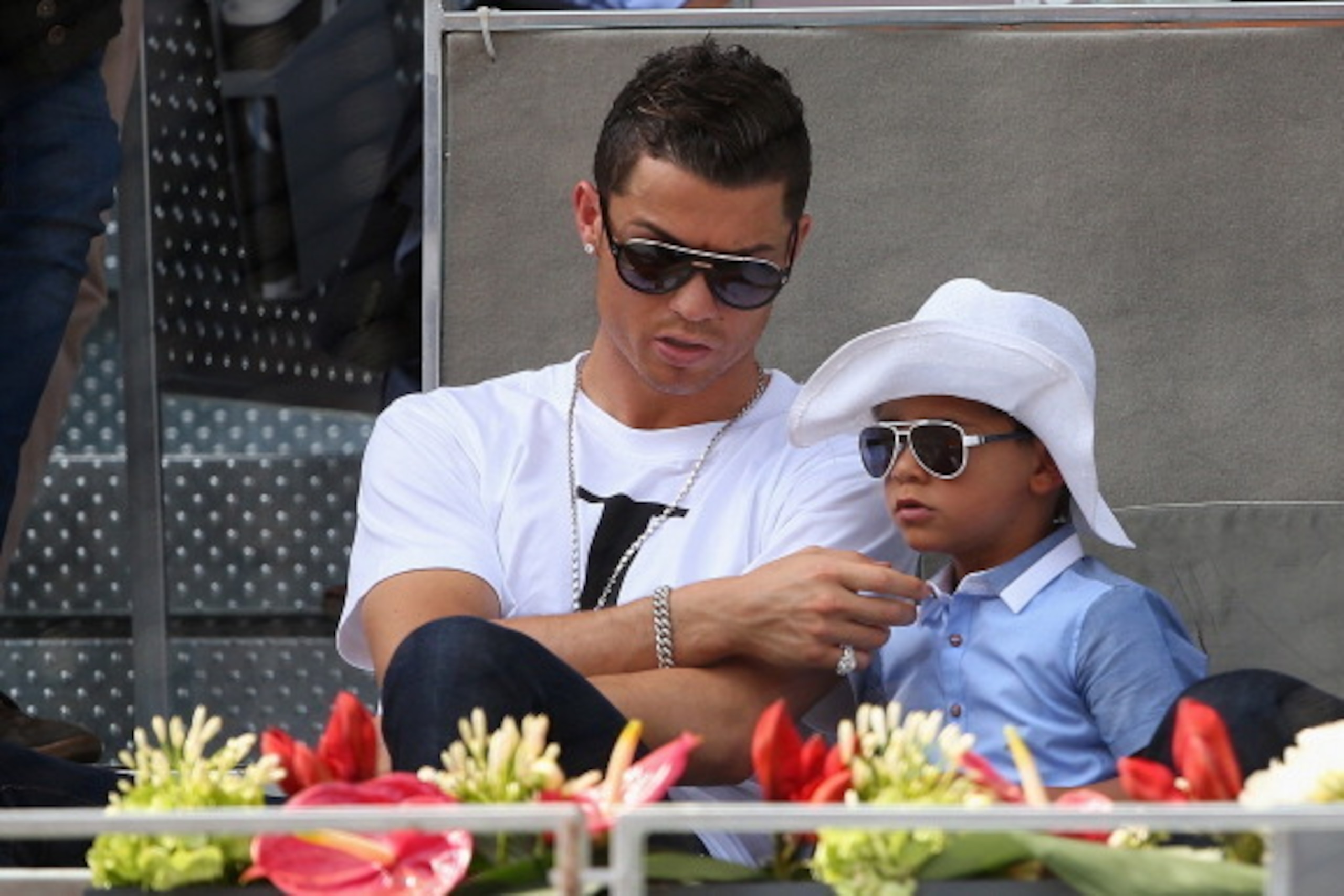 MADRID, SPAIN - MAY 08:  Real Madrid footballer Cristiano Ronaldo and his son Cristiano Ronaldo Junior watch Rafael Nadal of Spain against Jarkko Nieminen of Finland in their third round match during day six of the Mutua Madrid Open tennis tournament at t