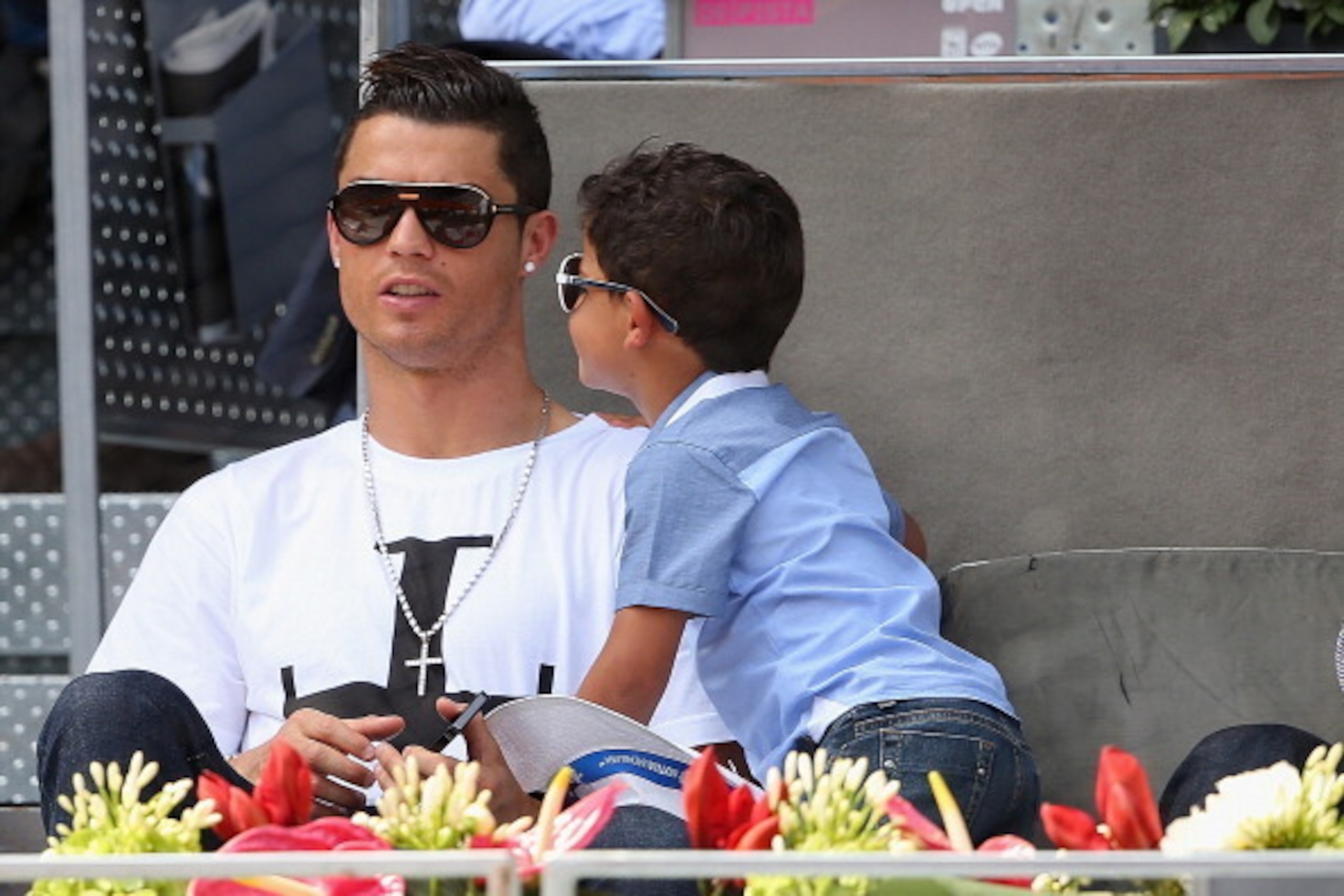 MADRID, SPAIN - MAY 08:  Real Madrid footballer Cristiano Ronaldo and his son Cristiano Ronaldo Junior watch Rafael Nadal of Spain against Jarkko Nieminen of Finland in their third round match during day six of the Mutua Madrid Open tennis tournament at t