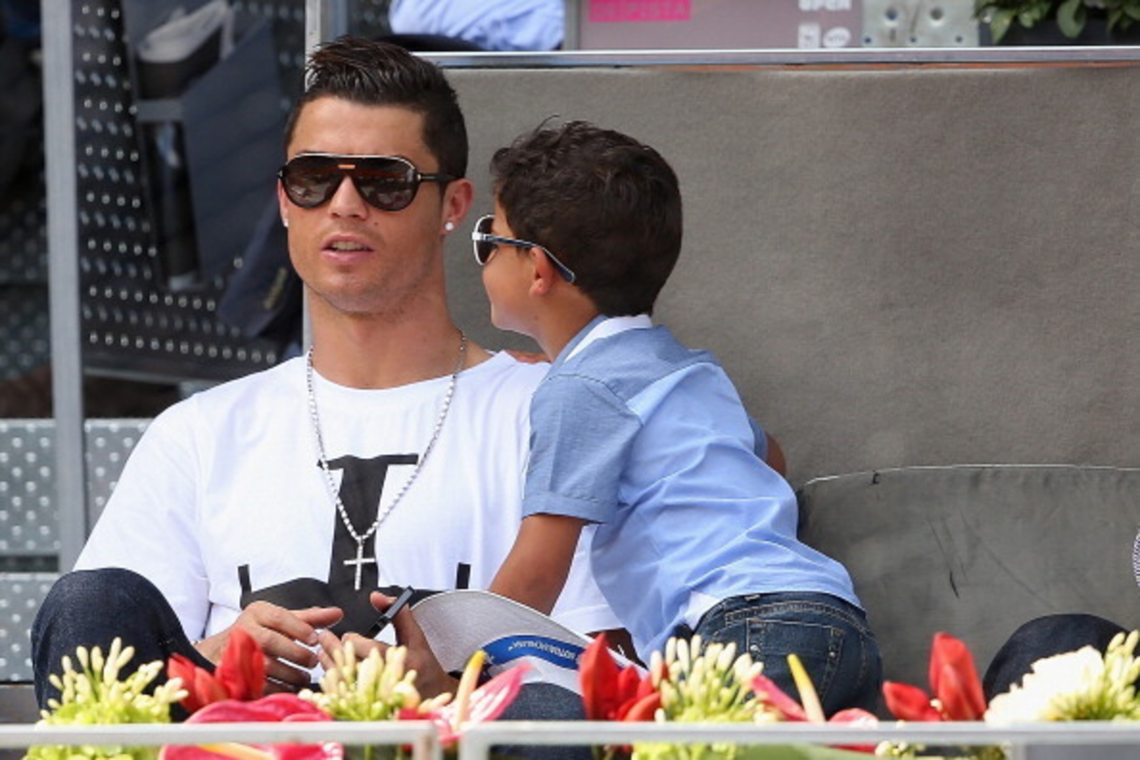 MADRID, SPAIN - MAY 08:  Real Madrid footballer Cristiano Ronaldo and his son Cristiano Ronaldo Junior watch Rafael Nadal of Spain against Jarkko Nieminen of Finland in their third round match during day six of the Mutua Madrid Open tennis tournament at t