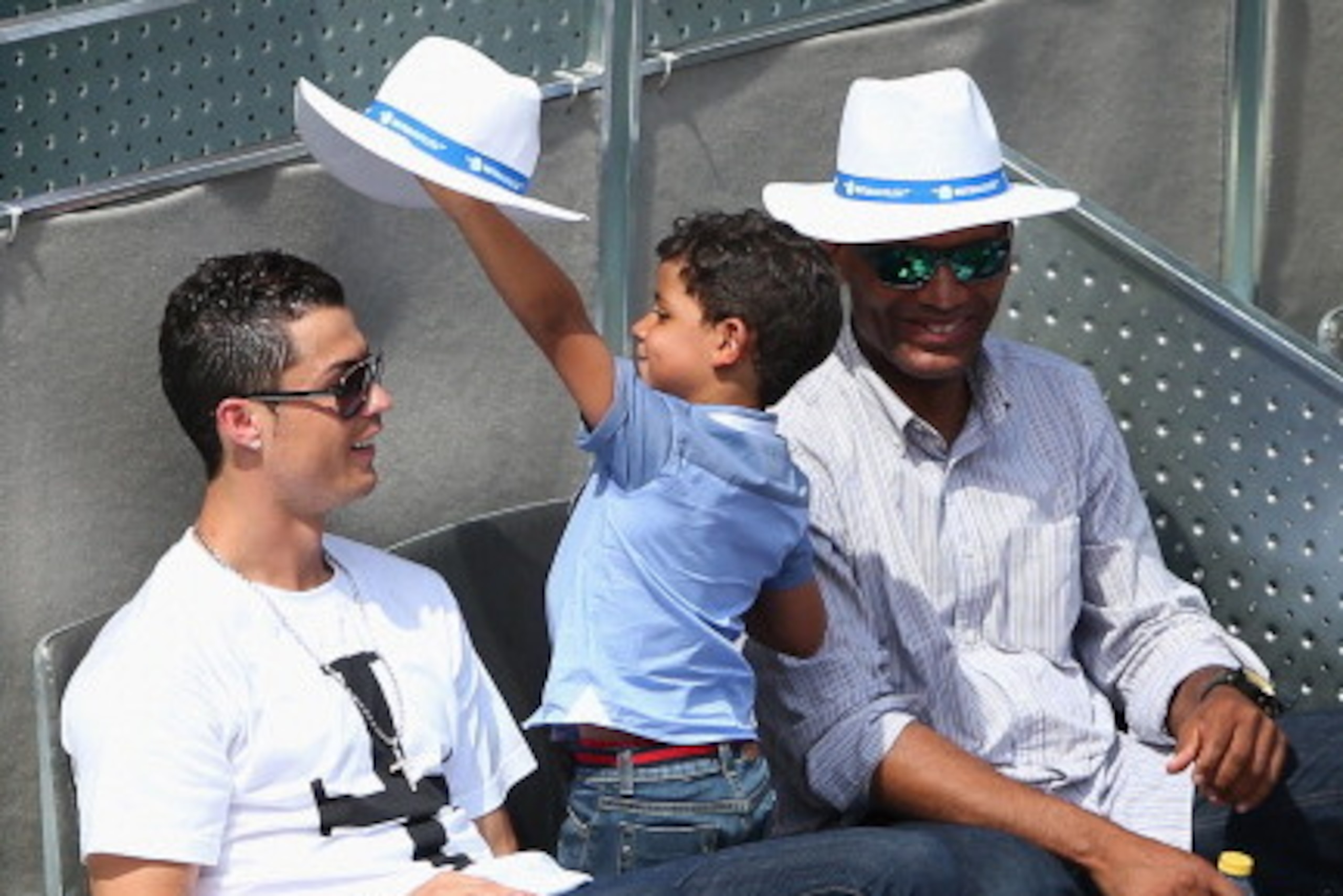 MADRID, SPAIN - MAY 08:  Cristiano Ronaldo with Cristiano Ronaldo Jnr as they watch Rafael Nadal of Spain play against Jarkko Nieminen of Finland during day six of the Mutua Madrid Open tennis tournament at the Caja Magica on May 8, 2014 in Madrid, Spain.