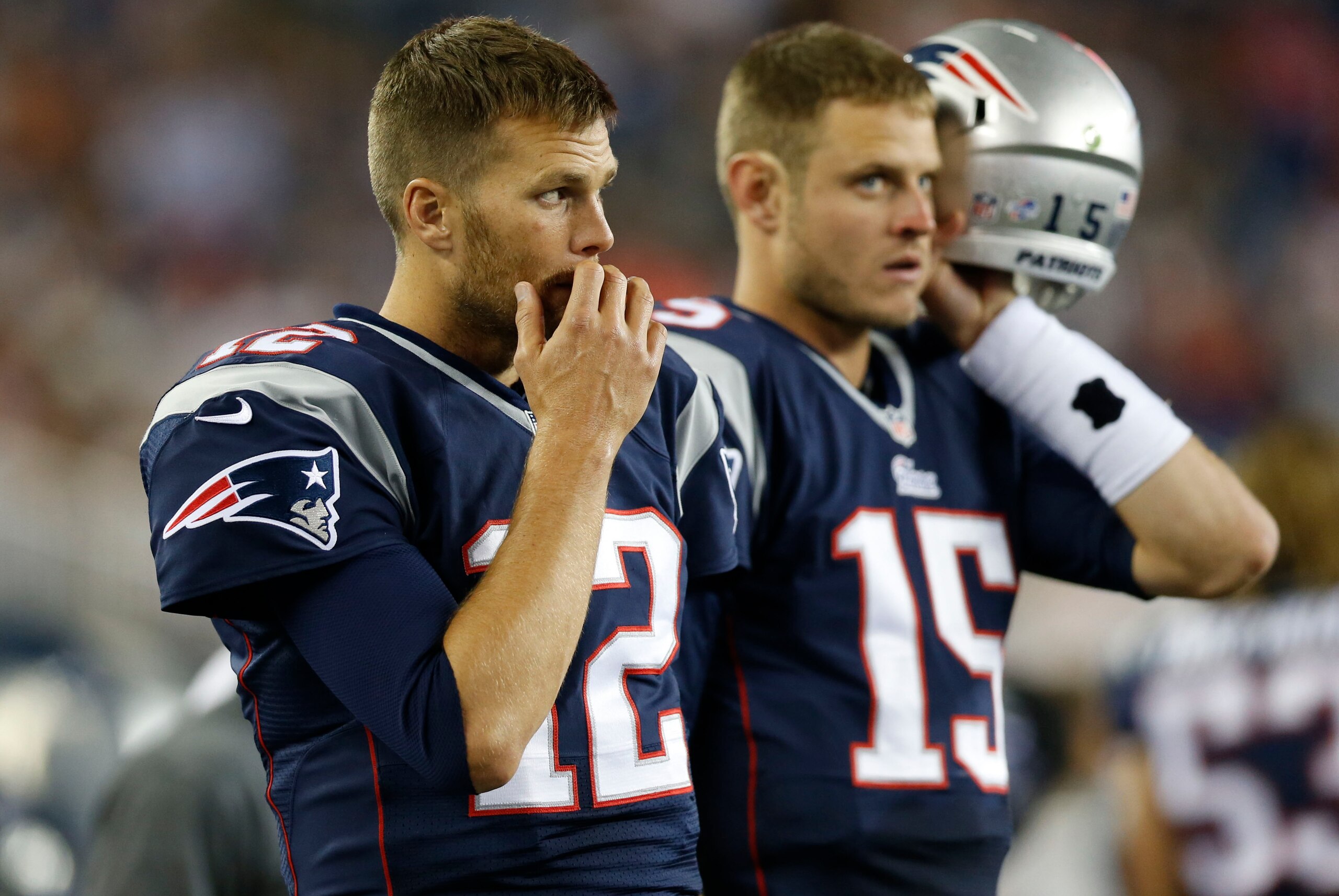 Aug 16, 2013; Foxborough, MA, USA; New England Patriots quarterback Tom Brady (12) and quarterback Ryan Mallett (15) on the sideline during the third quarter against the Tampa Bay Buccaneers at Gillette Stadium.  The New England Patriots won 25-21.  Manda