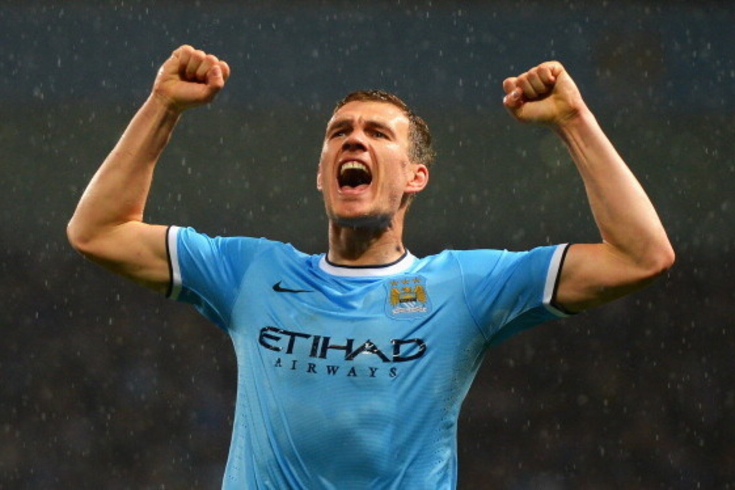 MANCHESTER, ENGLAND - MAY 07:  Edin Dzeko of Manchester City celebrates scoring the opening goal during the Barclays Premier League match between Manchester City and Aston Villa at Etihad Stadium on May 7, 2014 in Manchester, England.  (Photo by Michael R