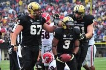 Oct 19, 2013; Nashville, TN, USA; Vanderbilt Commodores running back Jerron Seymour (3) celebrates with lineman Wesley Johnson (67) and tight end Steven Scheu (81) after Seymour scored a touchdown against the Georgia Bulldogs during the first half at Vand