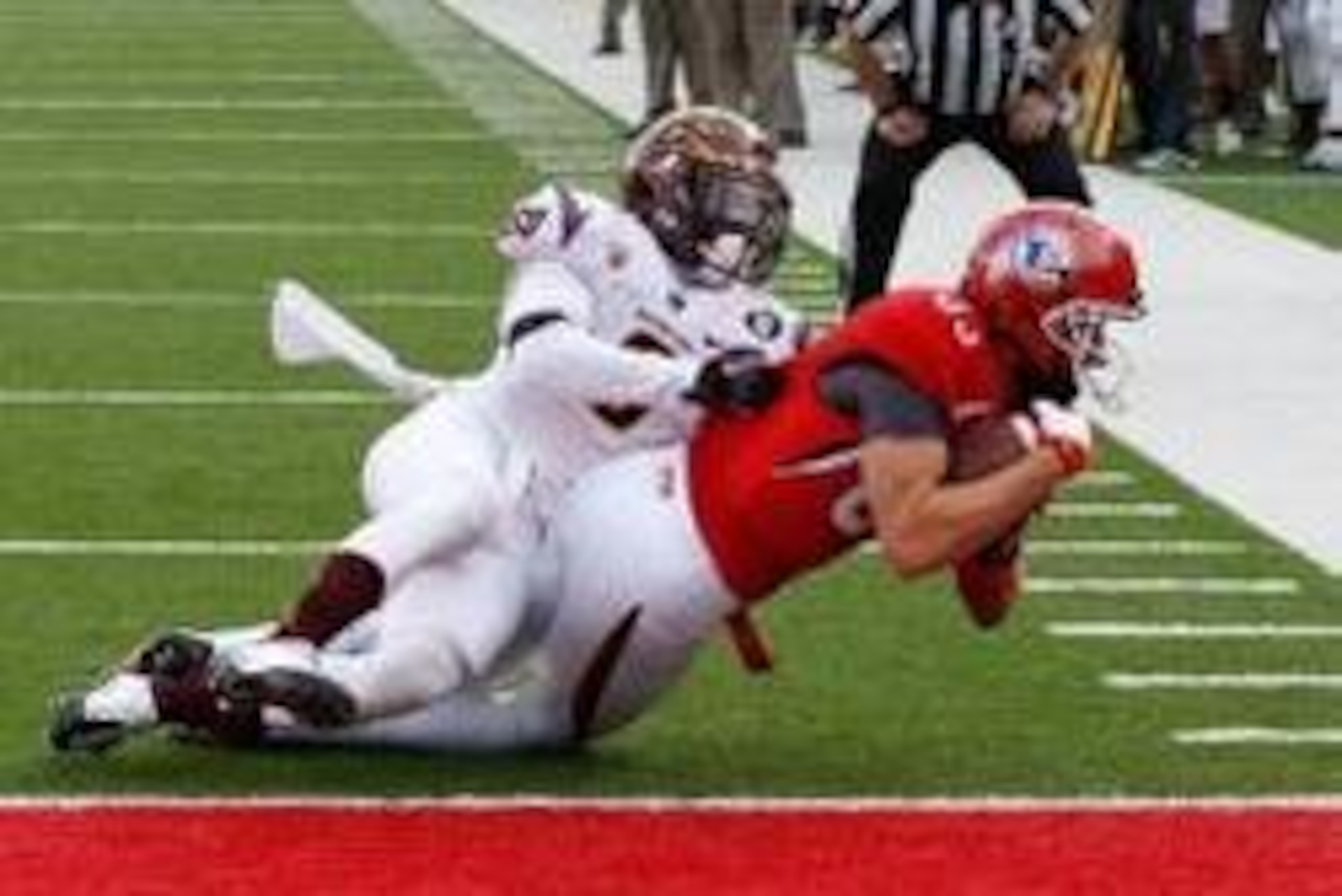 Nov 9, 2013; Salt Lake City, UT, USA; Utah Utes wide receiver Sean Fitzgerald (83) catches the ball and reaches to score a touch down while Utah Utes defensive end Trevor Reilly (9) tries to defend in the third quarter at Rice-Eccles Stadium. Arizona Stat