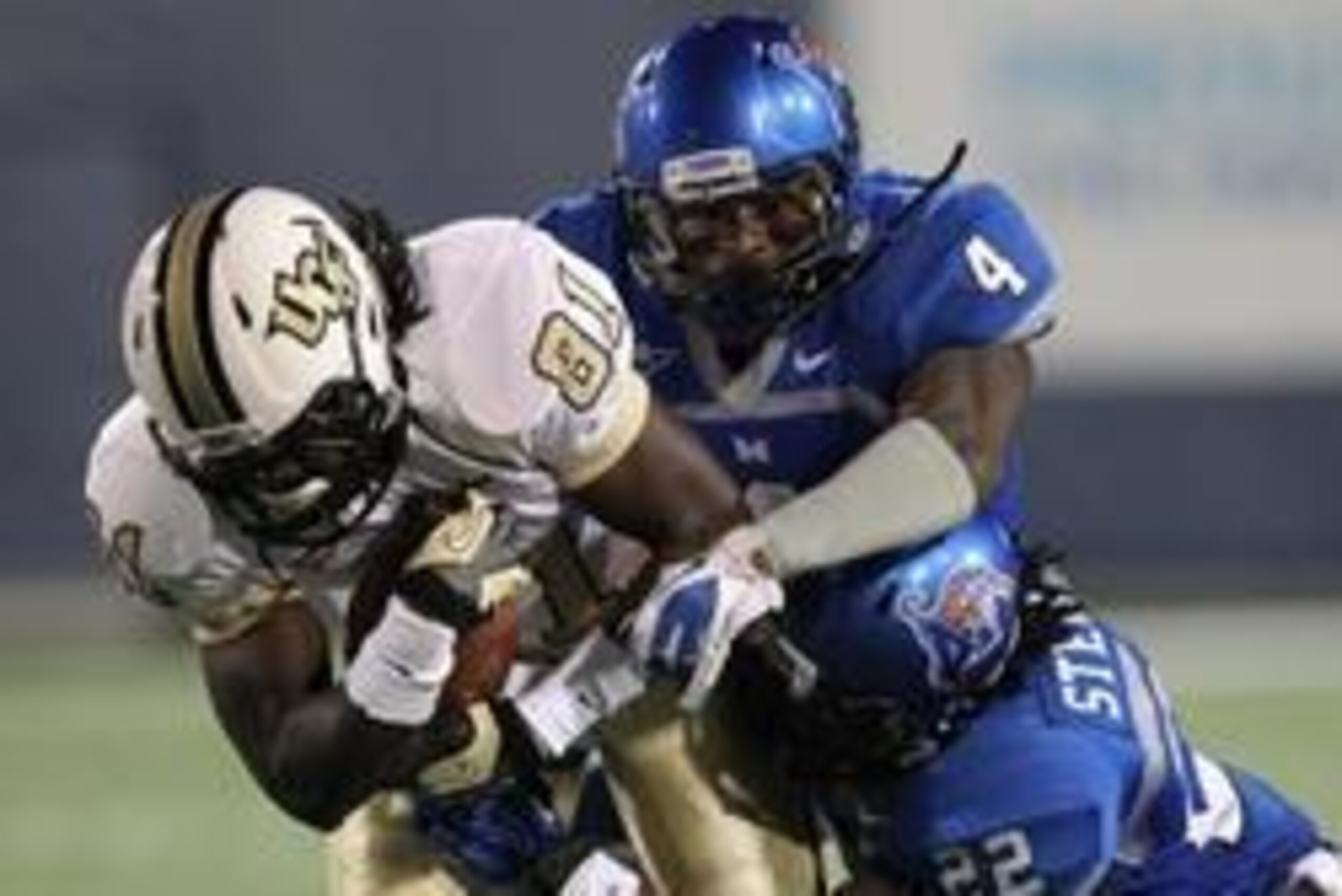 Oct 20, 2012; Memphis, TN, USA; Memphis Tigers wide receiver Breshad Perriman (81) is tackled by UCF Knights defensive backs Lonnie Ballentine (4) and Robert Steeples (22) at Liberty Bowl Memorial Stadium. UCF defeated Memphis 35-17.  Mandatory Credit: Ne