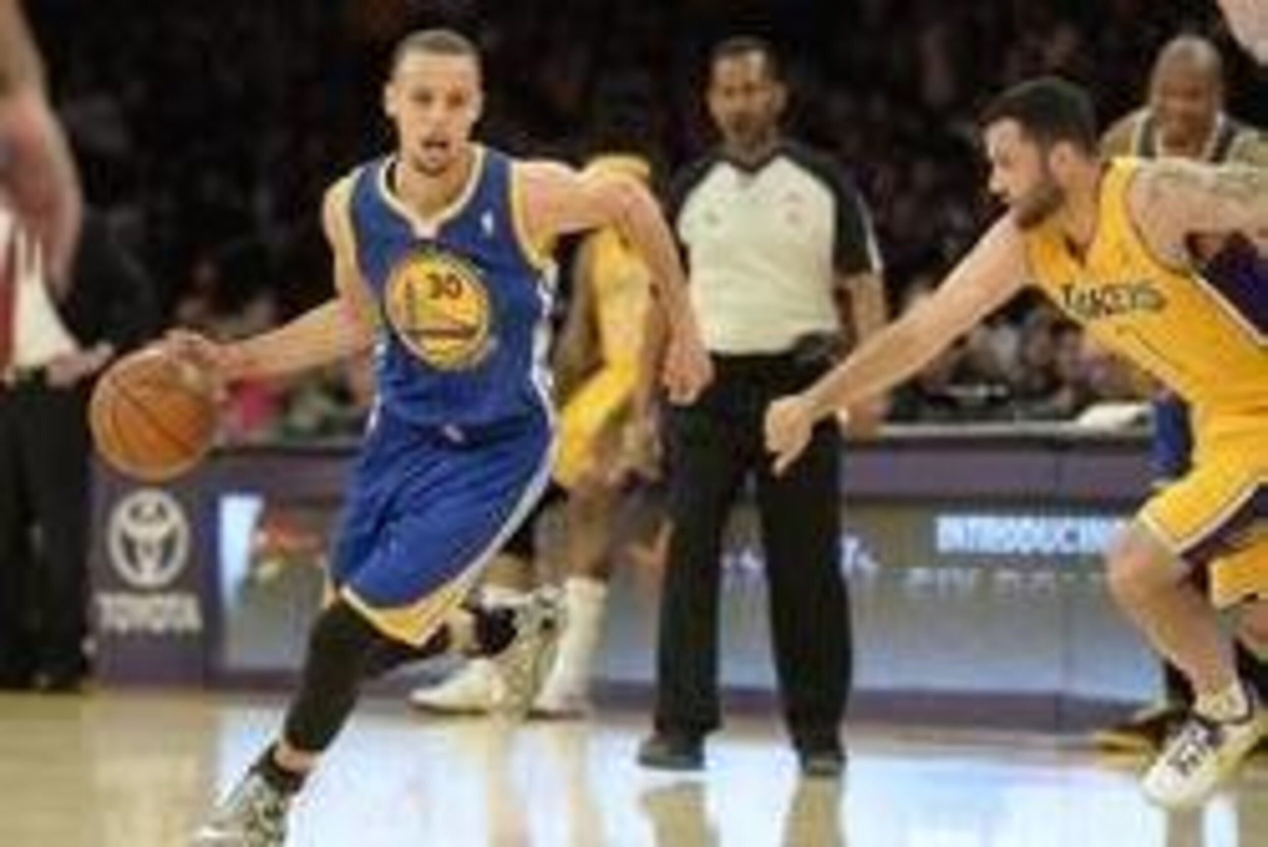 Apr 11, 2014; Los Angeles, CA, USA; Golden State Warriors guard Stephen Curry (30) dribbles around Los Angeles Lakers guard Jordan Farmar (1) at Staples Center. Mandatory Credit: Richard Mackson-USA TODAY Sports