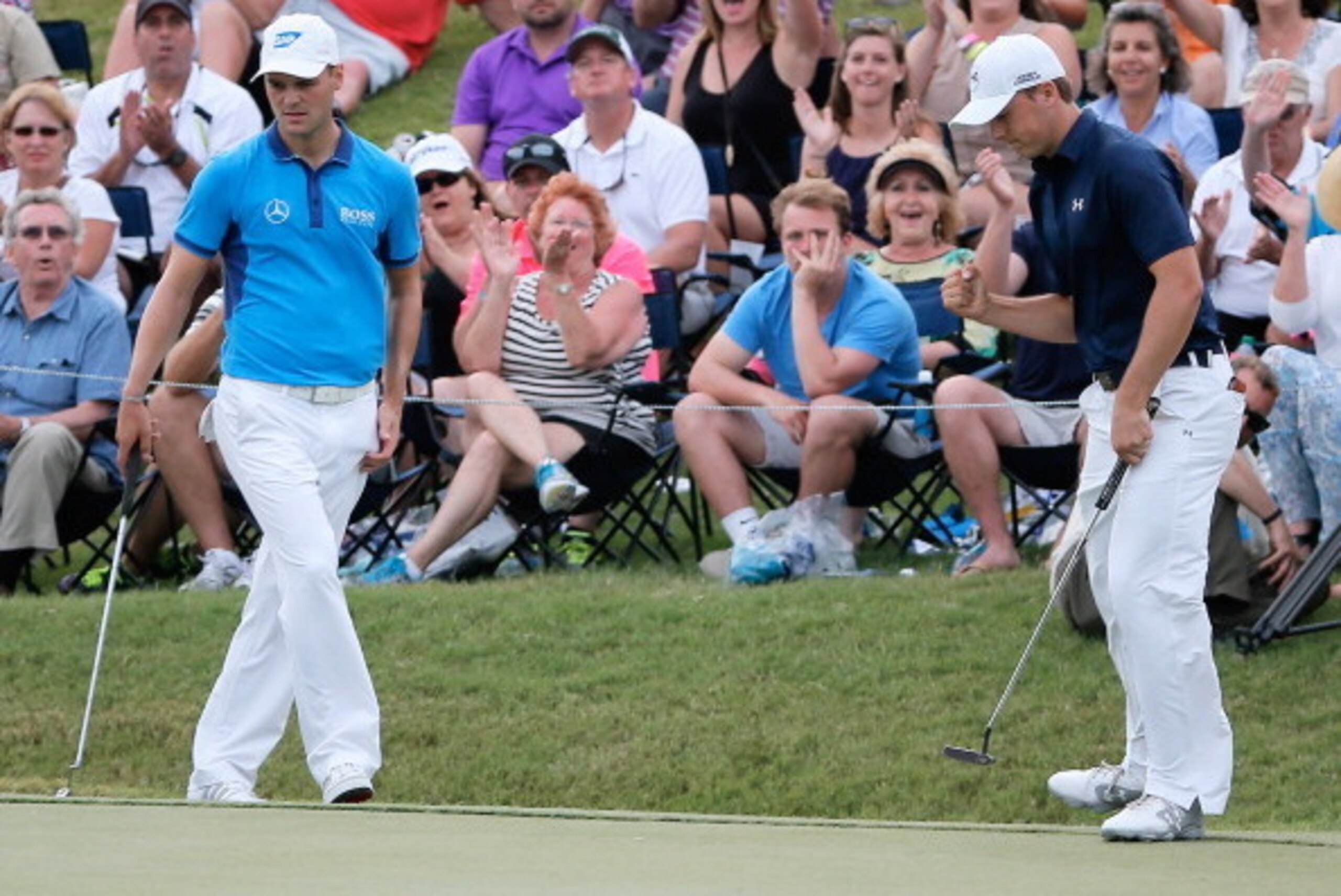 PONTE VEDRA BEACH, FL - MAY 10:  Jordan Spieth of the United States (R) saves par on the 18th hole as Martin Kaymer of Germany look on during the third round of THE PLAYERS Championship on the stadium course at TPC Sawgrass on May 10, 2014 in Ponte Vedra 