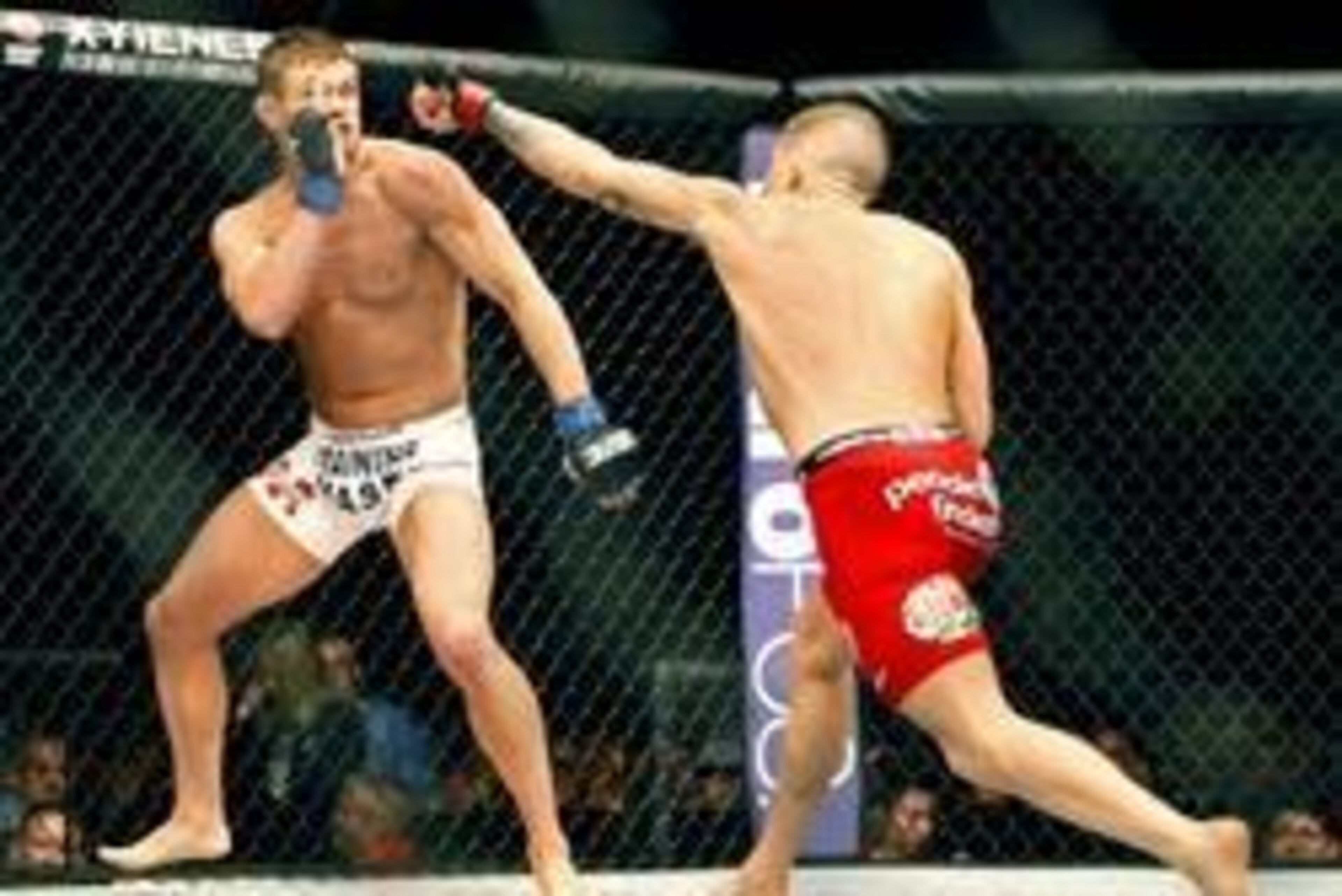 May 10, 2014; Cincinnati, OH, USA; Daron Cruickshank (blue gloves) fights Erik Koch (red gloves) during a lightweight bout at US Bank Arena. Mandatory Credit: Joe Maiorana-USA TODAY Sports