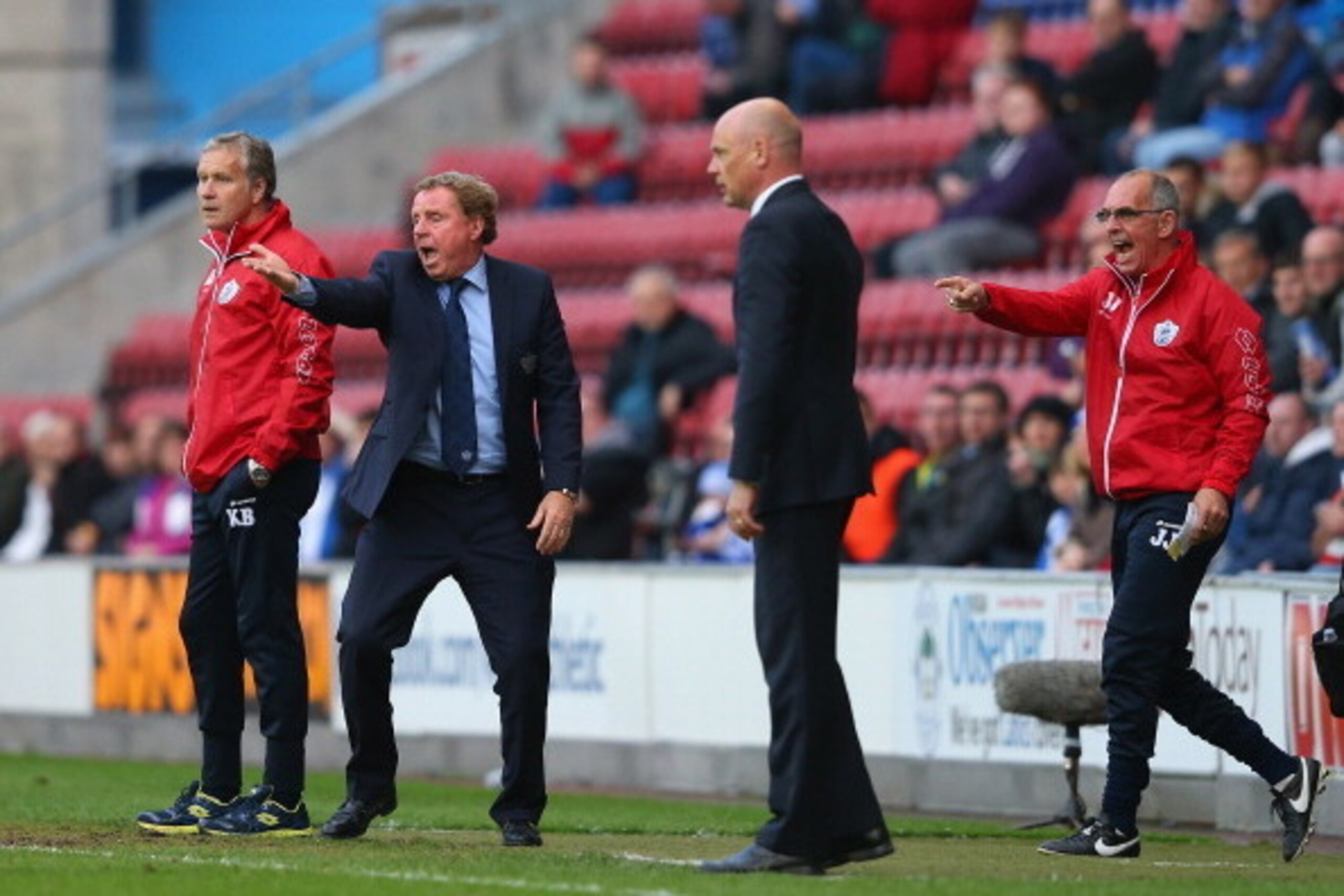WIGAN, ENGLAND - MAY 09:  Harry Redknapp the manager of Queens Park Rangers and his assistant Joe Jordan react as Uwe Rosler the manager of Wigan Athletic looks on during the Sky Bet Championship Play Off Semi Final first leg match between Wigan Athletic 