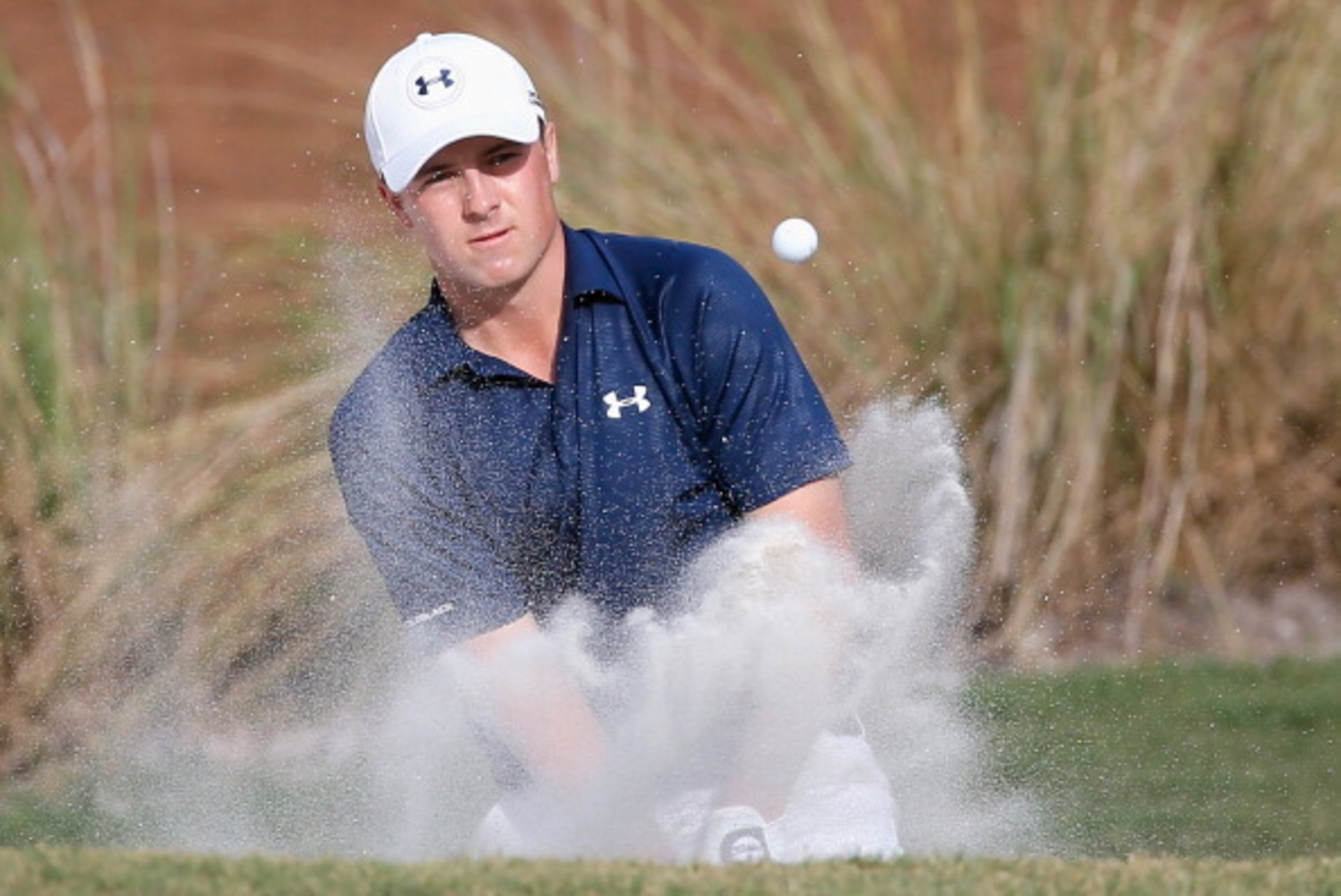 PONTE VEDRA BEACH, FL - MAY 10:  Jordan Spieth of the United States hits a bunker shot on the 14th hole during the third round of THE PLAYERS Championship on the stadium course at TPC Sawgrass on May 10, 2014 in Ponte Vedra Beach, Florida.  (Photo by Kevi