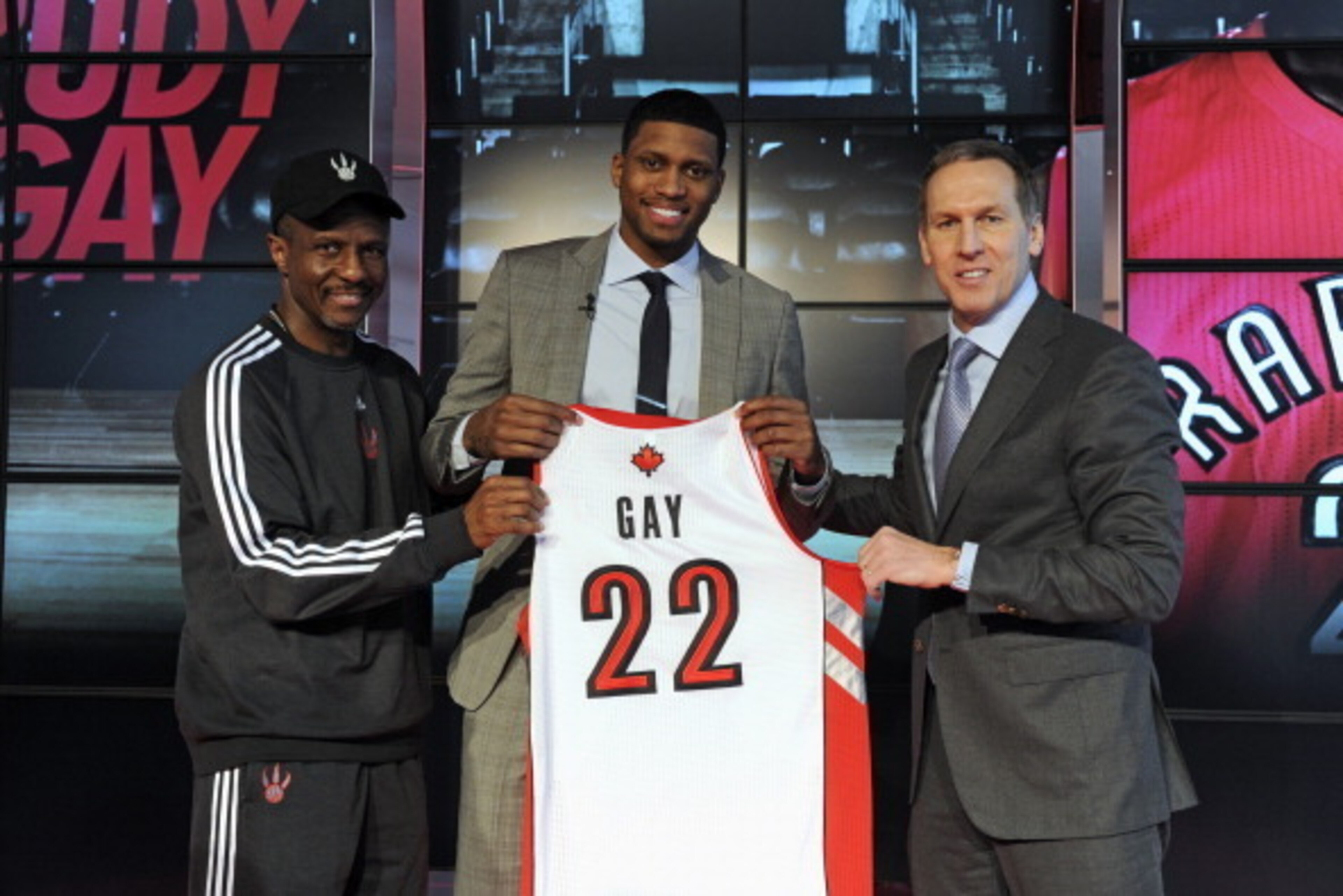 TORONTO,CANADA-FEBRUARY 01:  Newly acquired Rudy Gay of the Toronto Raptors with Dwane Casey and Bryan Colangelo of the Toronto Raptors during a press conference to announce his acquisition to the Toronto Raptors on February 1, 2013 at the Air Canada Cent